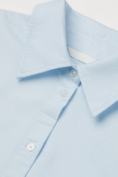 Long shirt in washed oxford cotton. Collar, buttons at front, and double-layered yoke at back wit... | H&M (US)