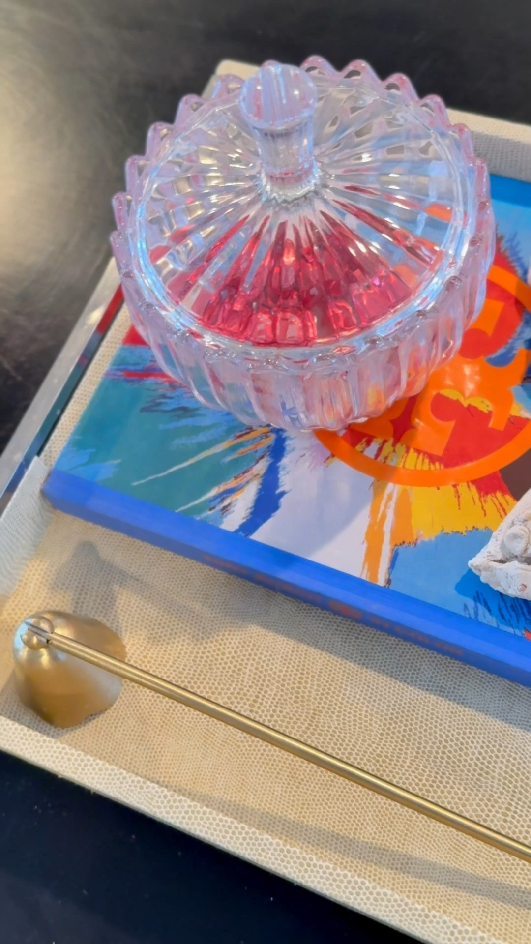 Coffee table styling update to give a little more color and bring some spring into this house. Candy dish and candle holder are from @Marshalls more recently. Candle snuffer, tray and books are older. Match holder is from a local store (and actually a shot glass/toothpick holder turned into match holder).

Coffee table, tray styling, spring decor. 

#LTKHome #LTKSeasonal