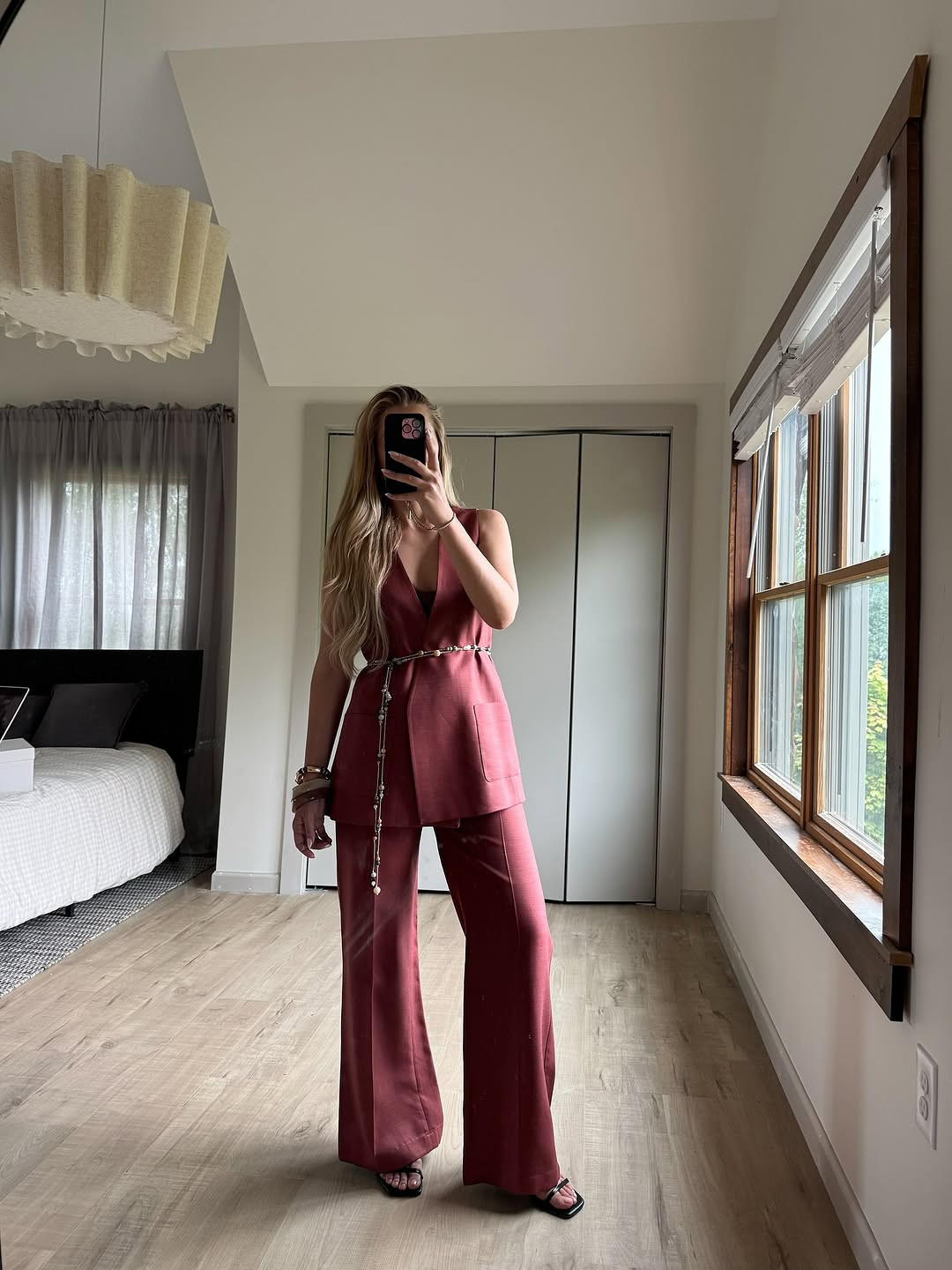 Crimson confidence. A chic sleeveless vest and wide-leg trouser suit in deep brick red, elevated by a delicate gold and pearl body chain. #TailoredSuit #CrimsonAesthetic #LTKworkwear 

 #LTKgrwm #LTKootd #LTKSaleAlert