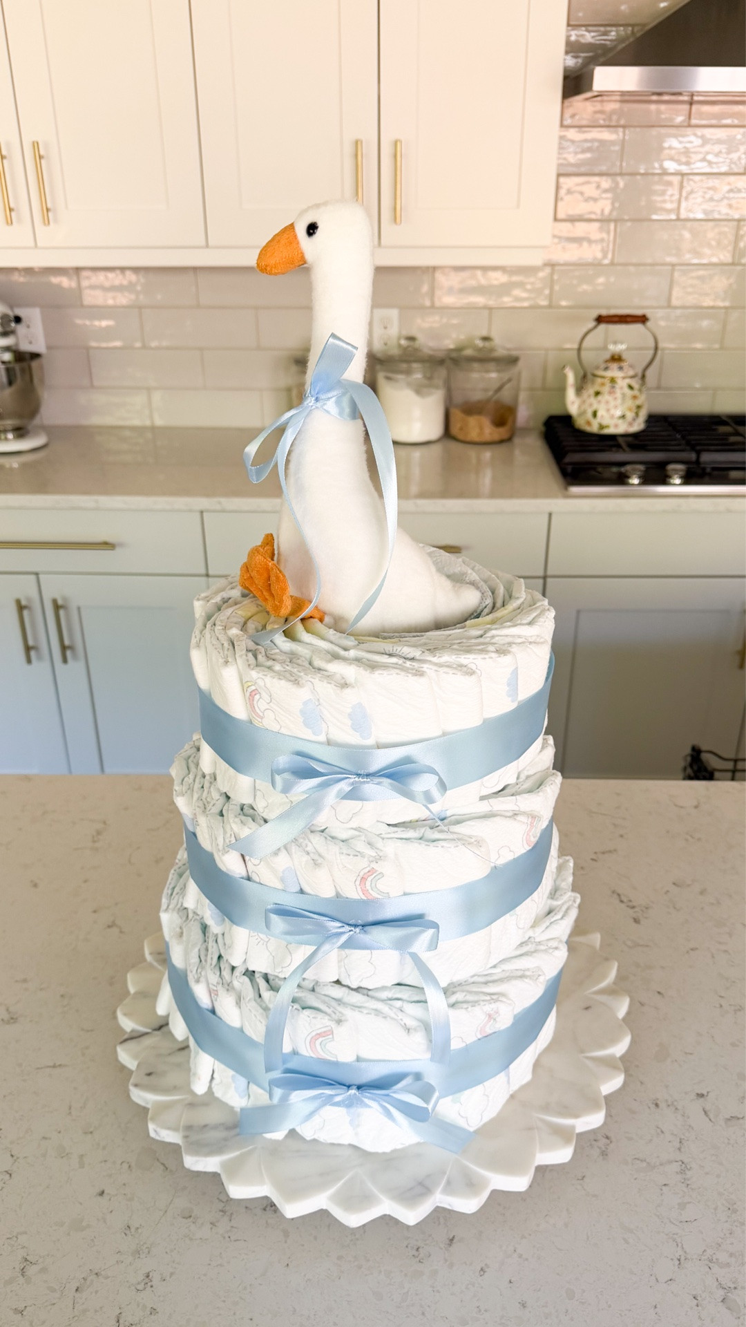 How I made this diaper cake without rolling any diapers! This was so fun to make for my friend’s Silly Goose is Almost on the Loose baby shower 💙🪿 #diapercake #babyshowerdecor

Silly goose themed diaper cake, Diaper, ribbon, rubber bands, round cake pan set, marble cake stand

#LTKsummer #LTKbaby #LTKmaternity