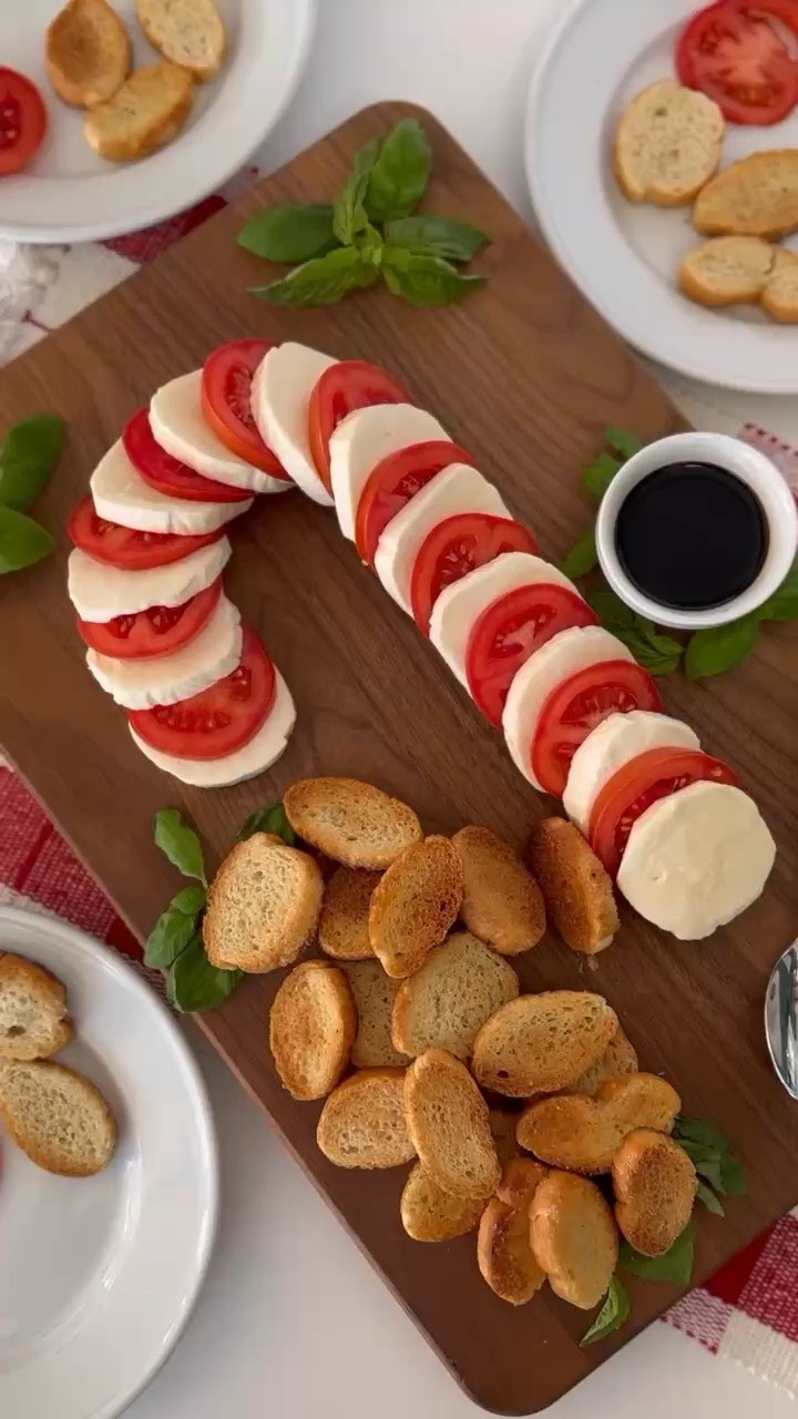 Cute Christmas appetizer alert! Tried the CANDY CANE CAPRESE APPETIZER from @thebakermama (https://www.instagram.com/thebakermama/) and it has quickly become a hit with our family! 🎄 Arrange and layer tomatoes & mozzarella cheese in the shape of a candy cane. The fresh basil gives it that festive red and green touch perfect for Christmas. And of course serve with toasted baguette from the grocery store bakery department and balsamic vinegar and salt! This is definitely become 
my new favorite Christmas appetizer. 🎄🩷

#LTKSeasonal #LTKHoliday #LTKWatchNow