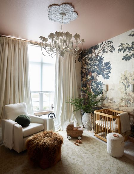 Girl nursery room with a mural wallpaper, balloon drapes and floral chandelier. Love the performance fabric ivory glider that’s so comfortable, a neutral rug and accessories that bring this room to life. 

#LTKhome #LTKfamily #LTKbaby