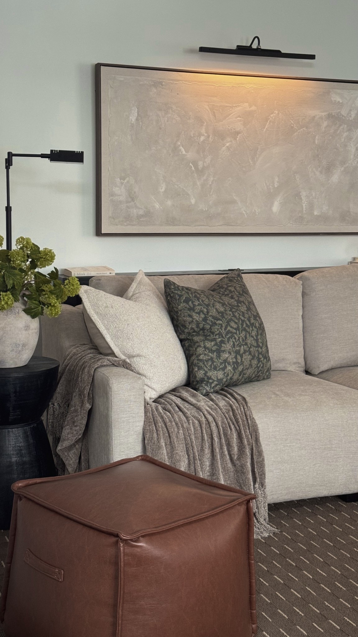 Just added a picture frame light to the space. It's coming together so nicely and I'm really excited for the coffee table to arrive soon.￼

Living room decor, living room couch, sleeper sofa, convertible sofa, end table, side table, pharmacy floor lamp, canvas wall art, sofa throw pillows, throw blanket, ottoman

#LTKHome