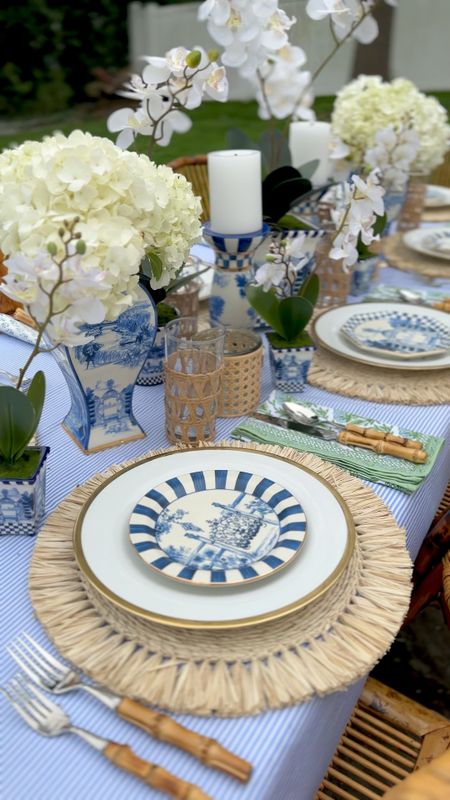 Beautiful outdoor entertaining is here again! Linking this blue and white striped tablecloth, green floral napkins, toile jars, faux orchids in toile planters, raffia chargers, bamboo flatware, cane wrapped glassware, toile candlesticks, toile plates, gold rimmed China, cane votive holders, bamboo folding chairs

#potterybarn #jcrew #mackenziechilds #tabletop #homedecor