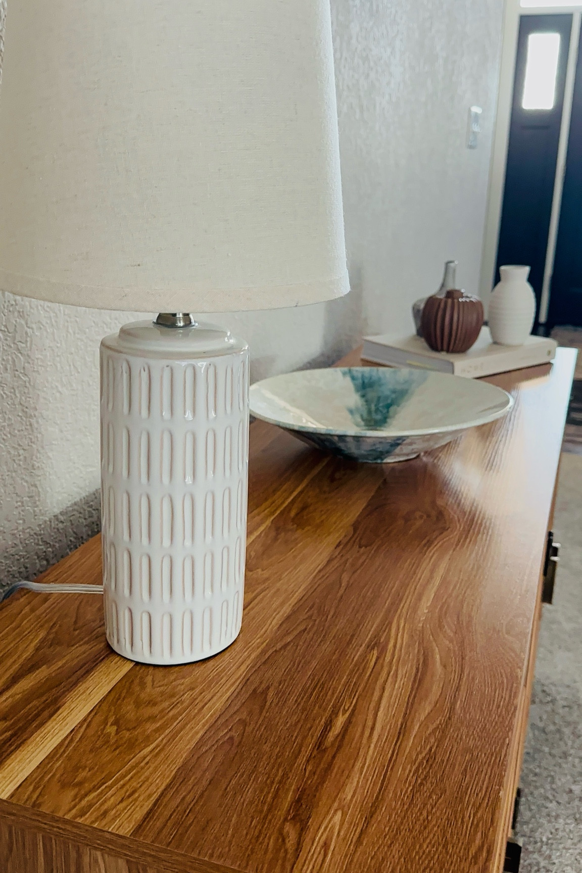 Shedding some light by adding this pretty lamp! Love styling my sidebar console table in our living room to give it a glow up. Typically, I style it in three sections with a lamp on one side, a bowl in the middle and in this styling a book as a riser for some height and three small vases. I’m sure the book and vases will change soon to a vase with some dramatic stems for spring. You may have noticed my tv art is already spring! I definitely am feeling the excitement of warmer weather one day in our future and longing for spring in Wisconsin! 

Have a great night!
xx Lisa

#consoletabledecor 
#neutraldecor 
#stylingideas 
#modernhome 
#lamp 
#ltkhomedecor 
#homeinspo 
#walmartfinds


#LTKHome #LTKSeasonal