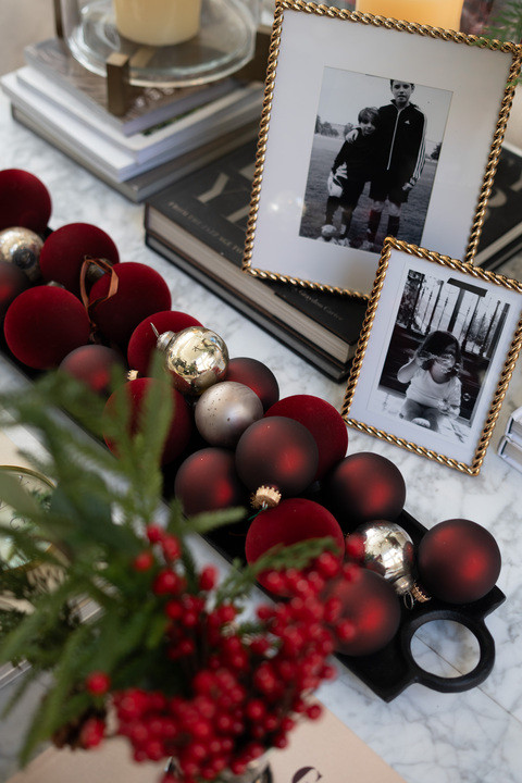OMG. These table details absolutely have my heart this season — deep red ornaments, touches of gold, and sweet family photos that make it all feel so personal and warm!! It’s the perfect blend of holiday sparkle and sentimental charm. Every piece tells a story, and together they create the most magical Christmas moment right at home. 

 #LTKHoliday #LTKSeasonal #LTKHome