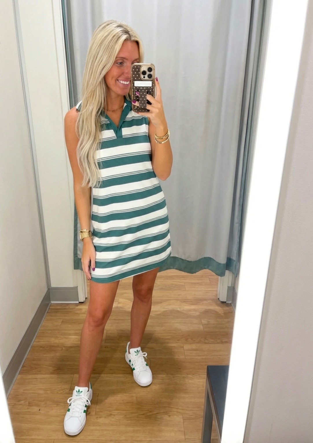 
Bright, lifestyle influencer selfie in a minimalist dressing room mirror. A stylish blonde woman with long beachy waves wears a green and white striped sleeveless polo dress paired with white Adidas sneakers and gold bracelets. The look is sporty-chic and effortless. Neutral dressing room background with soft lighting, clean wood floors, and a relaxed summer vibe. The aesthetic is preppy, travel-ready, and Instagram-worthy — Ralph Lauren meets casual golf resort style. The mood is confident, playful, and polished.

⸻

Caption

Sporty, comfy, and ready for wherever the day goes ✨
This is my favorite kind of outfit — easy, travel-ready, and cute enough for anything from running errands to grabbing lunch or hopping on a flight.

Athleisure but make it preppy chic 💚

—

⸻

Hashtags

#trendyheidi
#trendywithapassport
#sportychic
#athleisurestyle
#preppystyle
#summeroutfits
#everydaystyle
#adidasstyle
#casualchic
#airportoutfit
#weekendstyle
#tenniscore
#golfstyle
#traveloutfit
#effortlessstyle
#womenwithstyle
#styleinspo
#outfitinspo
#ootdfashion
#everydayfashion
#influencerstyle
#lookbookstyle
#amazonfashionfinds
#casualfashion
#fashionreels


#LTKgrwm #LTKSpringSale #LTKdayinmylife