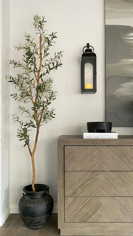PSA! My favorite tall, slim faux olive tree is on sale for $71 today! It is the perfect faux tree for sticking in the corner of any room, even smaller spaces and bedrooms because it is a great height, but does not take up much floor space. 👍

#OliveTree #NearlyNatural #FakeTree  #fauxtree #BedroomDecor #livingroomdecor #diningroomdecor #sideboard

#LTKsalealert #LTKhome #LTKfindsunder100