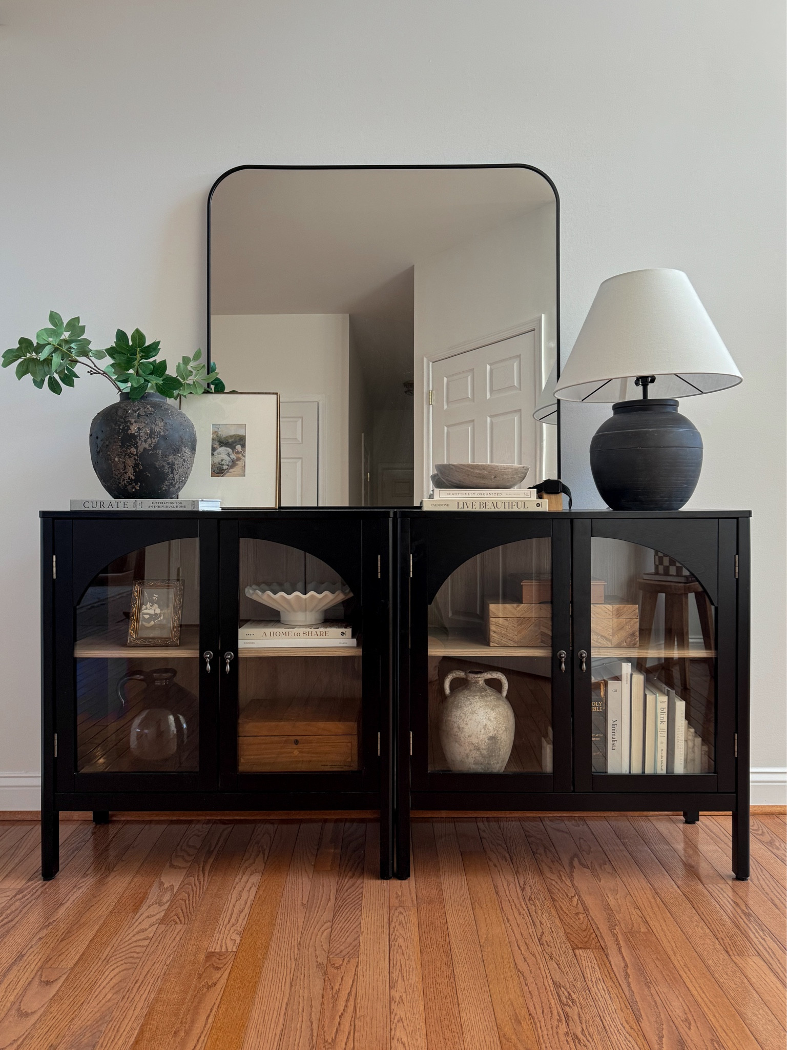 Spring entryway styling. 

Entryway decor, console table decor, cabinet decor, coffee table books, table, lamp, vase, spring stems, arch mirror, target style, vintage decor

#LTKhome