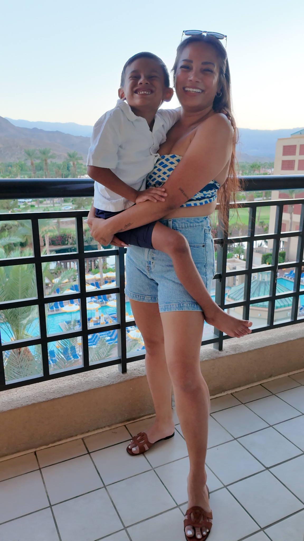 Resort wear mom & son outfit | wearing a scarf top, shorts (29), and sandals (7); resort shirt (5T), shorts (XS), and sneakers (12)

#LTKTravel #LTKxMadewell #LTKFamily