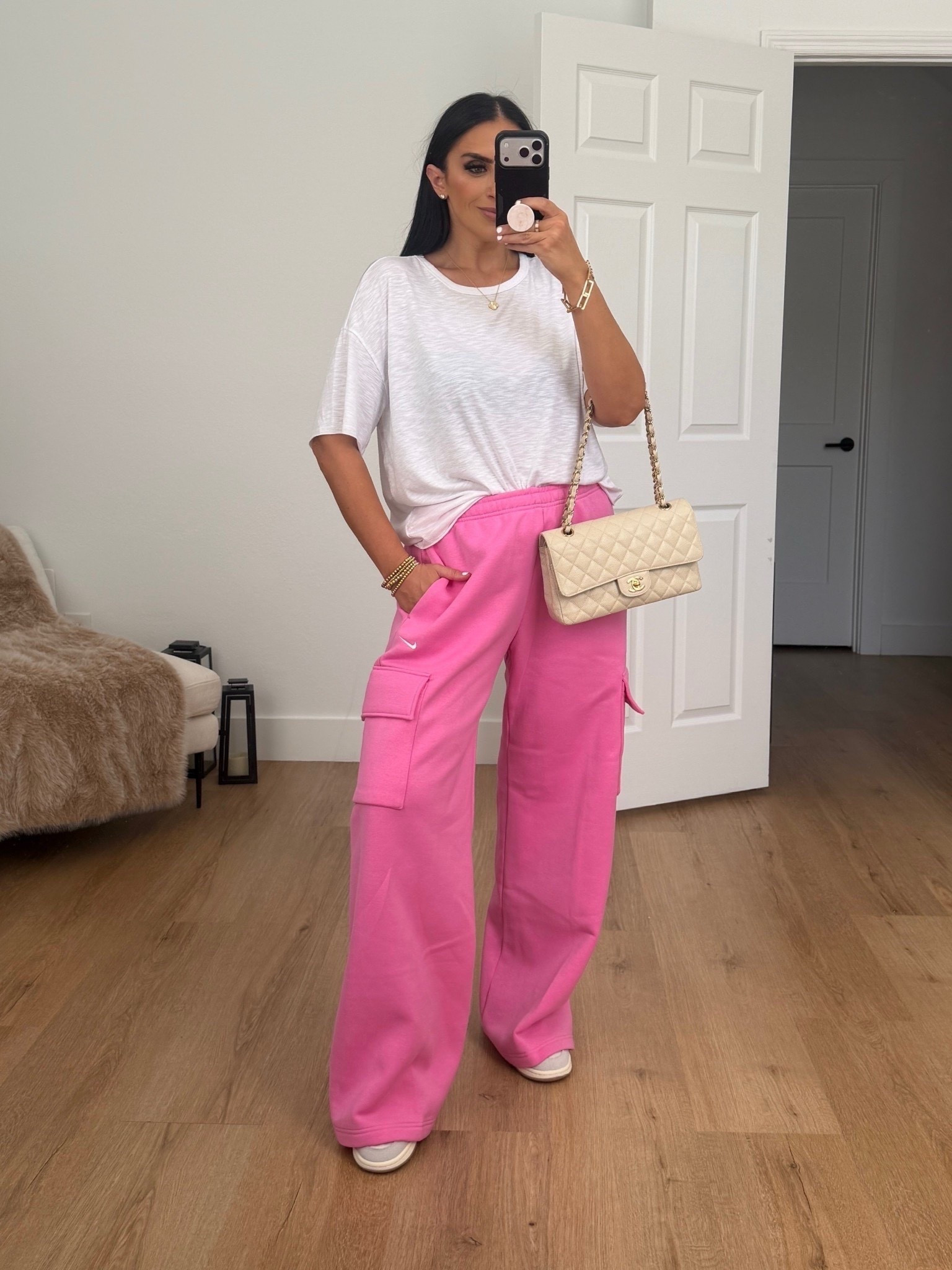 Woman’s Nike Sportswear Phoenix Fleece cargo pants. I’m wearing a size medium. 

Womans White Tshirt from Sofia Sofia. I’m wearing a size large. 
