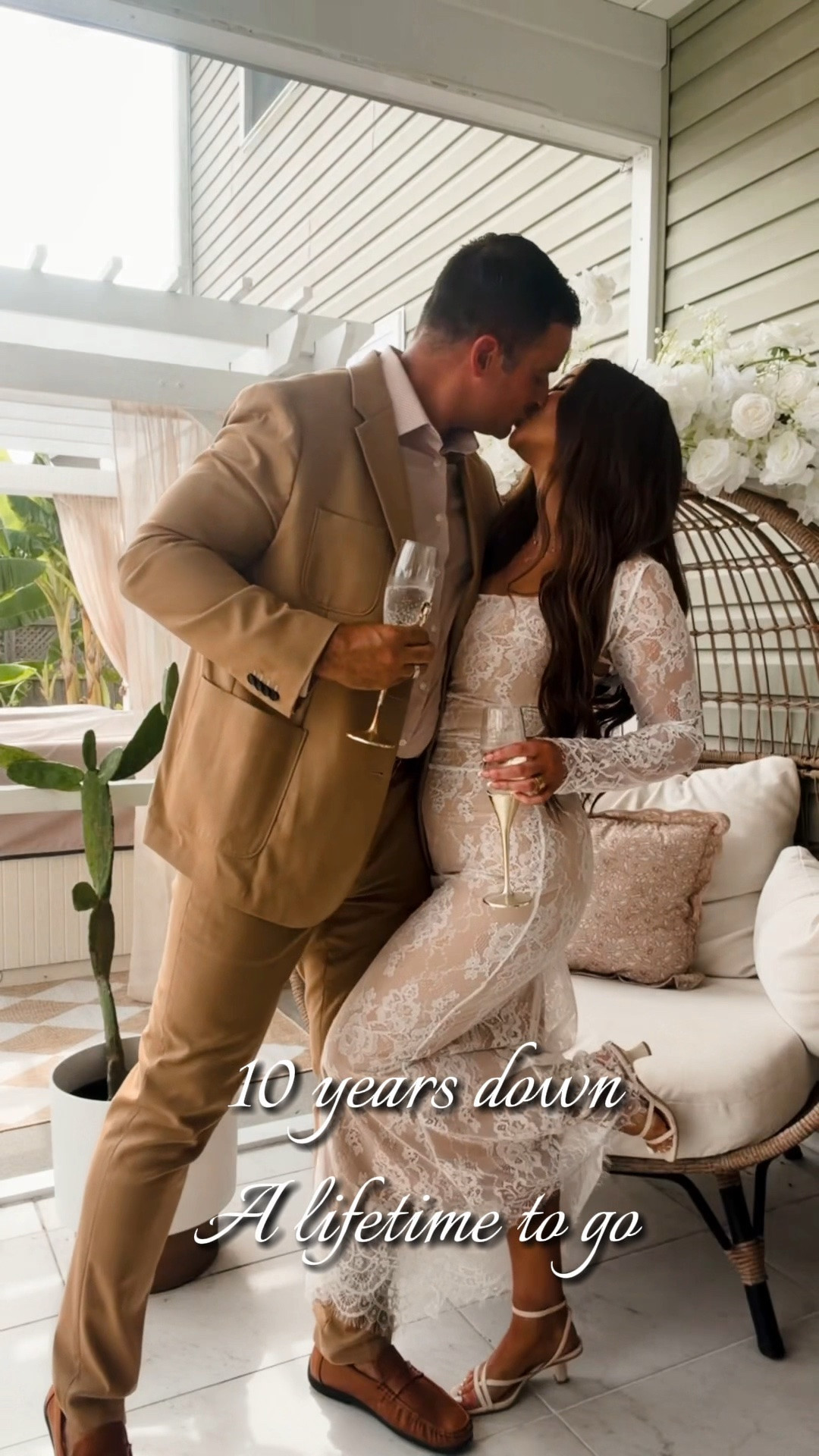 Lace fitted cream dress with long sleeve shrug that detaches-wearing a small
Tan brown mens suit
White faux wedding florals