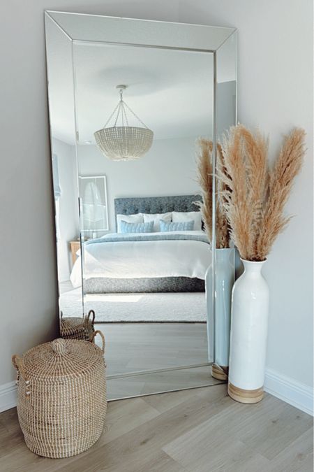 Modern Coastal Bedroom Inspo 🌊✨ Add this home decor + bedroom furniture to make your home feel bright, airy, + cozy with a touch of modern coastal vibes 🐚

For bedding, start with a classic white foundation by using the best-selling white honeycomb duvet cover + matching pillow shams. These have a subtle texture so it's not "blah."

Use the chambray cloud quilt to add a pop of color that gives the room the calming coastal color palette. 

Another way to add interest to the space is with decor! The white-washed wood bead chandelier adds character and charm while also brightening up the room.

The nightstands are shown in a seafrift finish which gives the bedroom a beachy, coastal look. This collection has a variety of size options and matching furniture (like dressers, storage...)

The palm leaf wall art helps to balance the room and adds to the coastal feel.

The oversized mirror makes the room appear larger. It’s styled with a large vase filled with dried pampas + a seagrass woven basket. This lidded basket comes is decorative + gives additional storage. 

Modern Coastal Bedroom, Master Bedroom, Home Decor, Modern Coastal Home, Neutral Home Decor, neutral bedroom, boho bedroom, Pottery Barn, Bedroom Inspiration, Florida Home, Beach House, Neutral bedding, guest bedroom, beach home, bedroom styling, bedroom wall art, bedroom chandelier, beaded chandelier, master bedroom styling, master bedroom decor, beach home decor, Sausalito nightstand, natural wood nightstand, bedroom set, bedroom furniture, master bedroom bedding, neutral comforter, coastal bedding, white bedding, blue bedding, nightstand styling, cozy bedroom, bedroom lighting, coastal art, coastal wall art, coastal decor, neutral home decorative objects, oversized mirror, wall mirror, baskets, blanket basket, storage basket, bedroom storage, floor vase, oversized vase, chunky knit handwoven rug, ivory rug, hurricane candleholders, Sausalito nightstands 

#LTKStyleTip #LTKSaleAlert #LTKHome