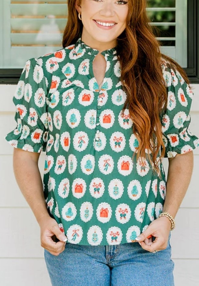 Lauren Christmas Top 🎄✨

The sweetest festive blouse from Layerz Clothing — the Lauren Top in the Christmas print is soft, cheerful, and so easy to dress up or down for all your holiday plans. The green background with playful Christmas icons (tiny wreaths, bows, presents, mistletoe!) gives it that fun, boutique holiday vibe without being over the top. I wear the XS for a comfortable, relaxed fit.

The ruffled quarter sleeves and keyhole neckline add such a flattering feminine touch, and the 100% cotton fabric makes it lightweight and breathable for all-day wear. Perfect for school events, church, cookie decorating, family gatherings, or a cute casual December outfit with jeans.

Holiday inspo: Layerz Clothing Christmas, festive boutique top, green holiday blouse, Christmas outfit ideas, cheerful holiday prints, seasonal tops for women, winter wardrobe favorites.

#LTKPlusSize #LTKFindsUnder100 #LTKHoliday