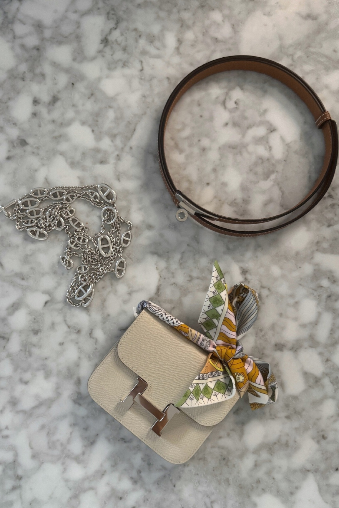 Perfect accessories to pair with a Constance Slim Hermès belt bag. A brown adjustable Hermès Kelly belt, a long Hermès chain necklace in silver and a chic Hermès Twilly silk scarf🤍

#LTKStyleTip #LTKItBag