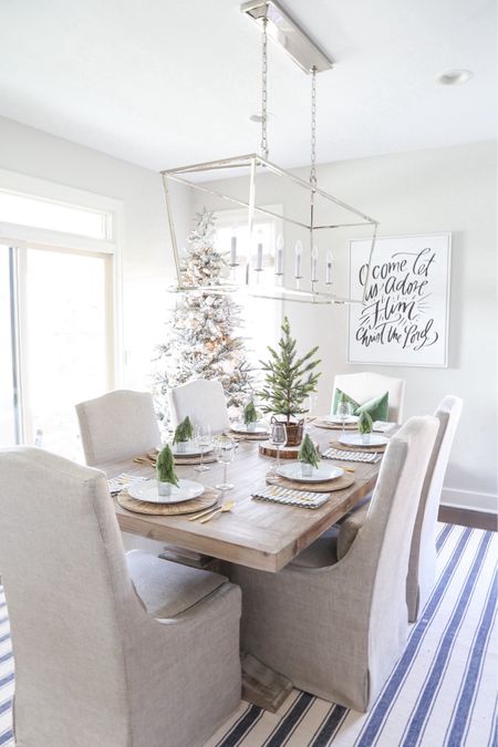 Our Christmas dining room from several years ago is still a favorite! Items include an oversized linear dining room light, faux flocked Christmas tree, distressed wood chargers, striped linen napkins and gold place setting. Other items include a blue and white striped rug, linen chairs and a large, antique wood dining room table. 

Target home decor, Target finds, christmas décor, amazon décor, christmas pillows, target christmas, dining room decor, family room décor, amazon home, amazon Christmas, amazon finds, pottery barn décor, #ltkfamily  #ltksale 

#LTKfindsunder50 #LTKfindsunder100 #LTKSeasonal #LTKhome #LTKsalealert #LTKstyletip #LTKhome #LTKHoliday #LTKSeasonal