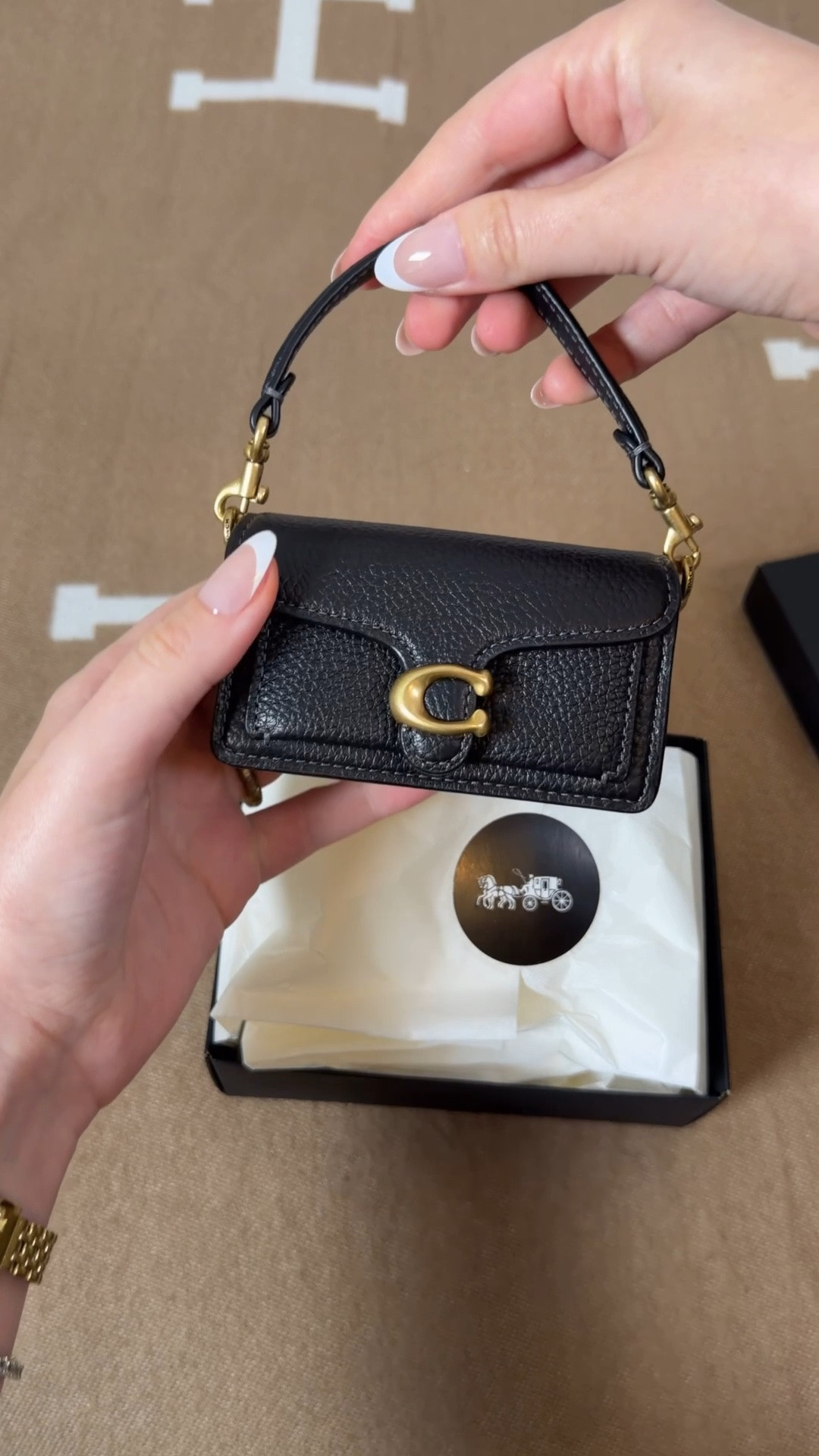 The teeniest lil bag 😍 Comment SHOP & I’ll dm you the link 🖤

This mini coach tabby comes with short strap to wear as a little wristlet handbag, or a bag charm. It also come with a long chain so you can wear it as a crossbody. Fits your id, cards and lip gloss for a night out 🖤

Coach mini tabby charm
