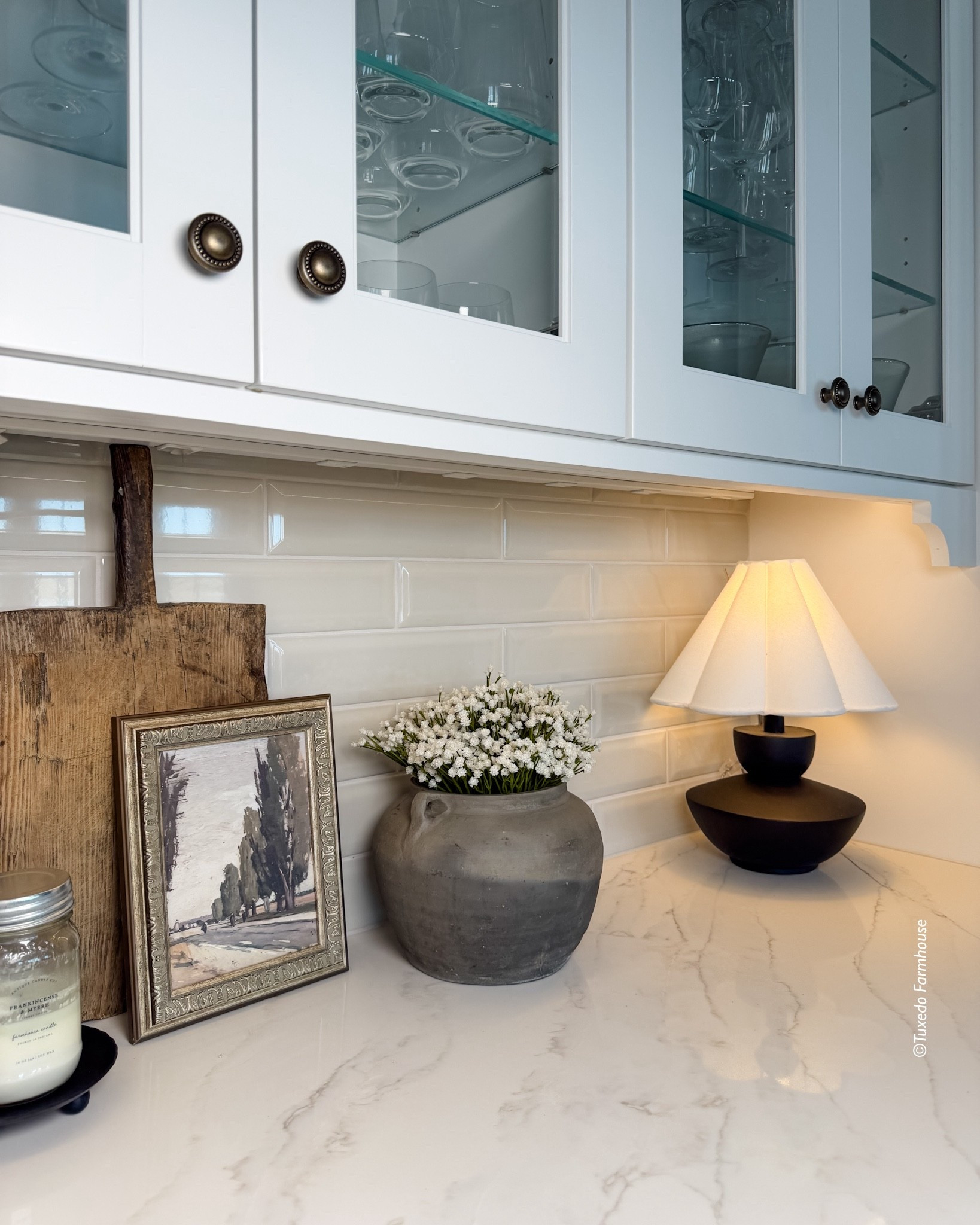 Simple counter styling inspo! A whimsical but elegant lamp brings personality, a vintage bread board adds warmth and character, and a small piece of art layers in charm and personality. Finished with a soft pot of baby’s breath, the look feels effortless, collected, and perfectly balanced between cozy and fresh. 

 #LTKSeasonal #LTKHome