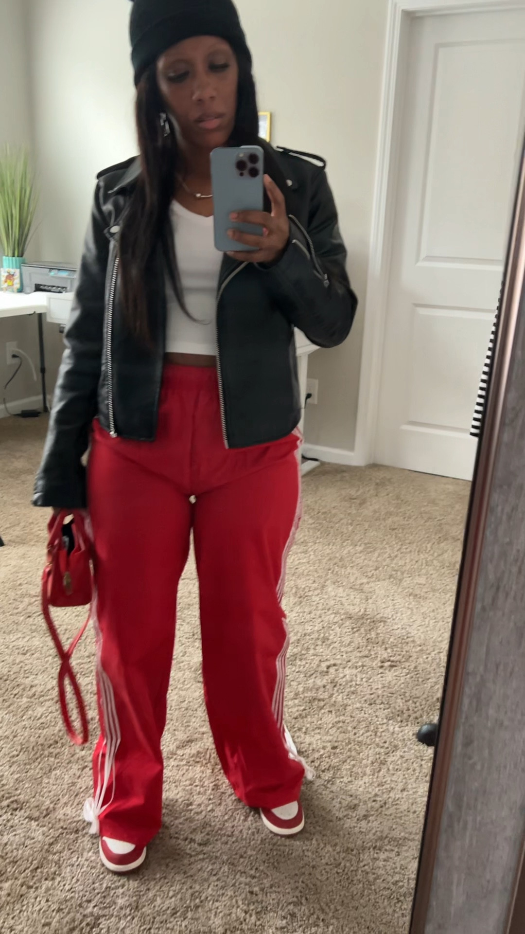 How to style track pants with a white tee and black faux leather jacket. I styled this outfit with a black beanie, red purse, and Jordan 1 sneakers

#LTKStyleTip #LTKFindsUnder50 #LTKFindsUnder100