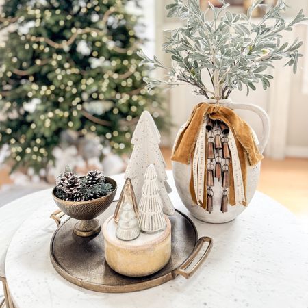 Dress up your vases for the holidays!  Just adding ribbon and bells makes this living room coffee table more festive! #christmasdecor #christmaslivingroom #coffeetableideas 

#LTKSeasonal #LTKHoliday #LTKCyberWeek