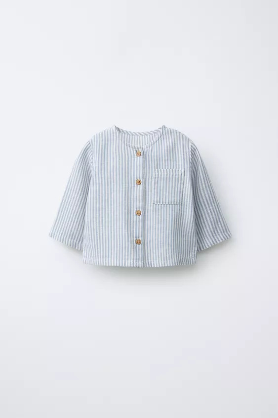 Round neck shirt with long sleeves. Button-up front fastening. Patch pocket on the chest. Made of... | Zara UK