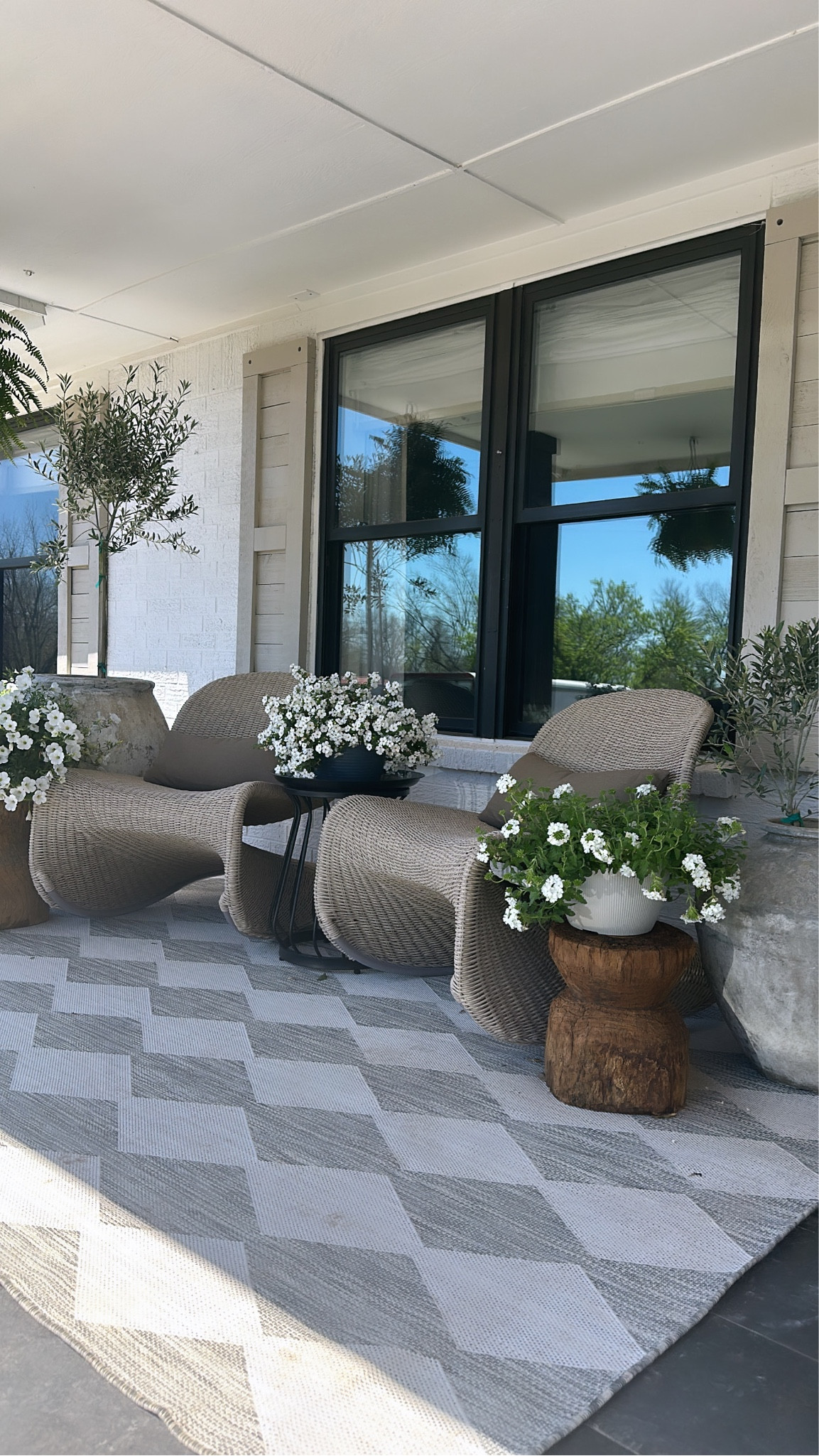 The earthy modern porch of my dreams! These rocking chairs are stunning! Outdoor furniture, rug, planters. Spring porch  

#LTKhome #LTKSeasonal
