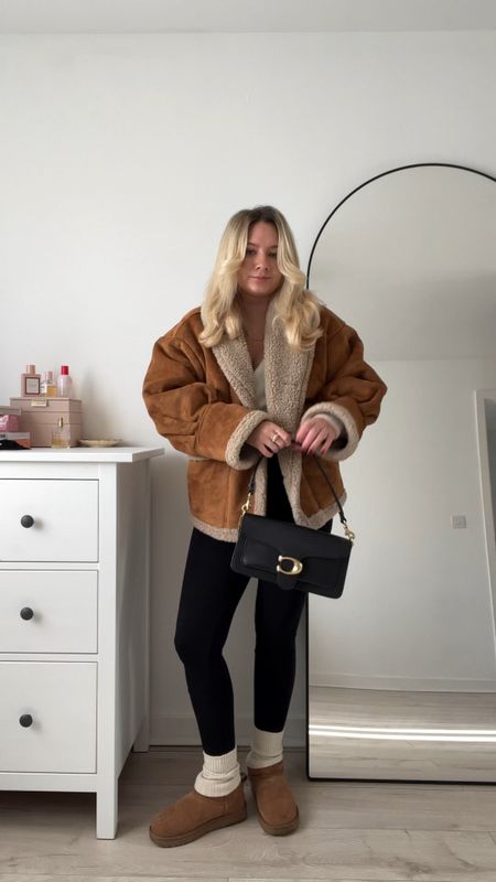 a cosy outfit featuring a black seamless ribbed unitard/jumpsuit, cosy cream socks, brown ugg ultra minis, a cream ivory wraparound fluffy cardigan, an oversized brown shearling coat and a black coach tabby shoulder bag 🫶🏻🧸

#LTKeurope #LTKstyletip #LTKsalealert