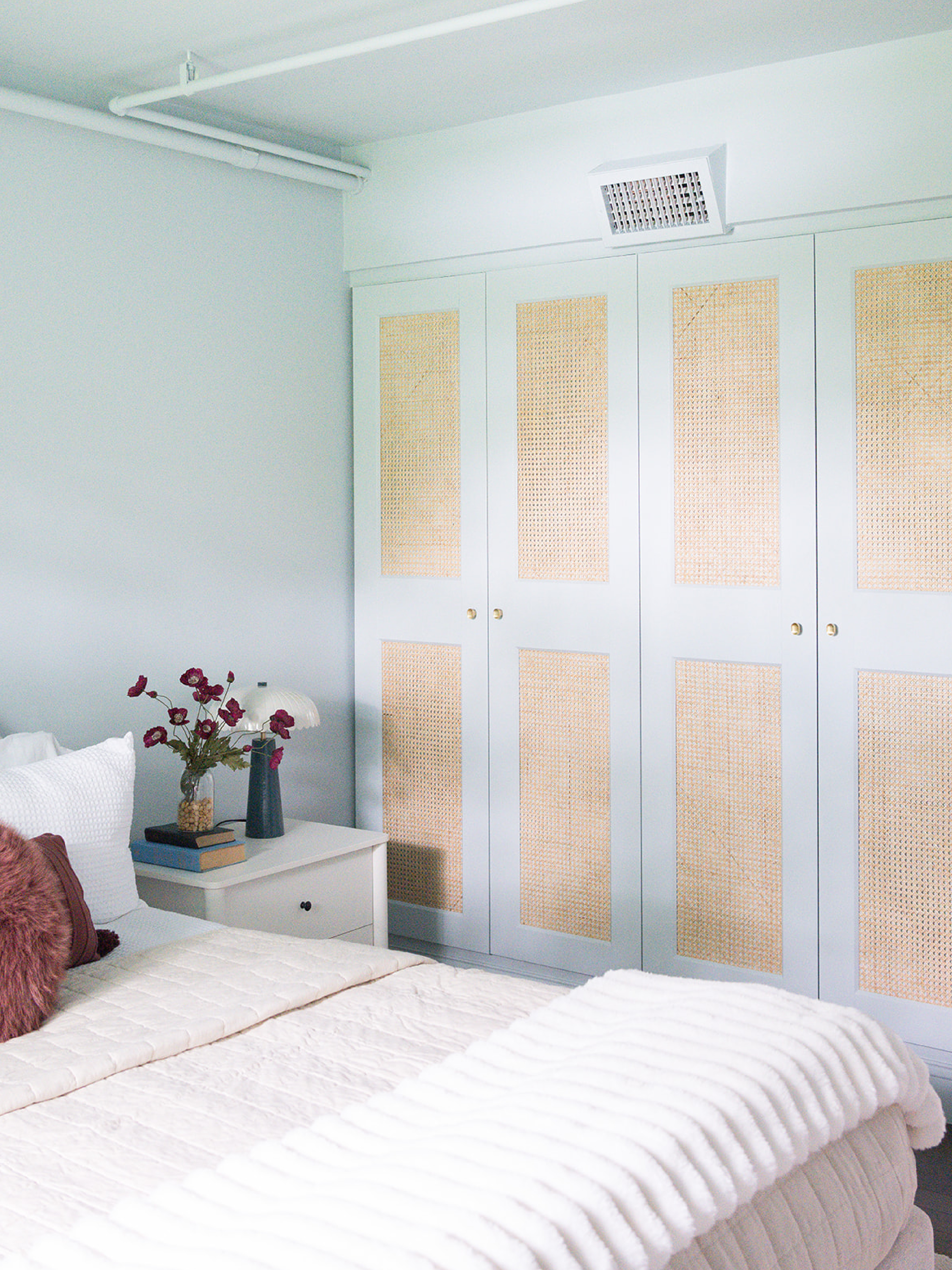 new #dwelloctoberstudio project alert! we’re excited to share the finished photos of this condo renovation in downtown Salem. the design of this project was inspired by a Parisian apartment, so when the bedroom lacked storage, we added built-in wardrobes using @ikea boxes fitted with DIY cane doors. we painted the cabinets the same soft blue color as the walls, ceiling, and trim to give the room a chic feel while bringing some much needed light into the space. organically-shaped gold knobs add the finishing touch to these functional and beautiful built-ins. #dwelloctober 

 #LTKHome