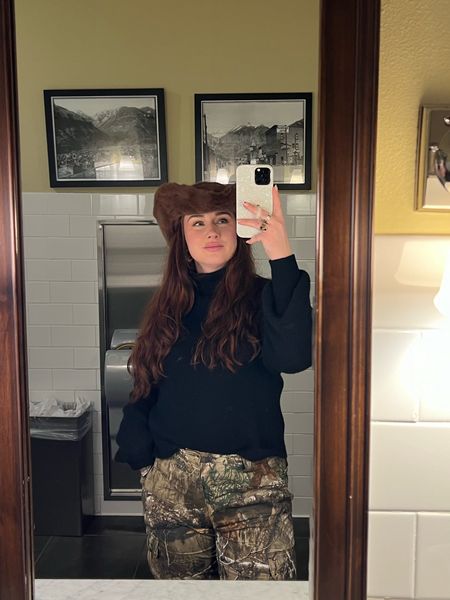 Was half lit when I took this!! Incorporating camo pants into more feminine styles is so fun. Wearing a size men’s medium here, staple black sweater, and mango fur cowboy hat. Sadly this hat is sold out but linked some similar ones!

#LTKstyletip #LTKtravel #LTKSeasonal