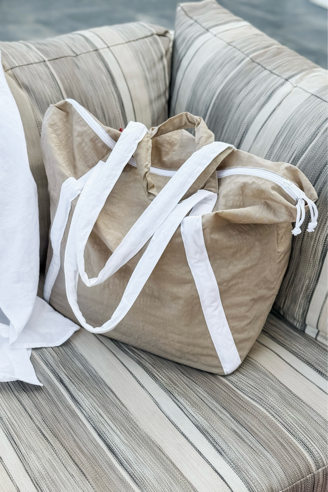 This tote has been a WORKHORSE on this tropical vacation — since it has a VERY loose designer tote bag vibe I still felt put together when carrying it, but didn’t have to worry about my actual designer bags getting ruined by the pool or on the sandy beach. I absolutely love the durability of the exterior waterproof(!) and sand proof nylon fabric, the interior zipper pouch for securing smaller items and it’s pleasantly roomy inside (which easily fits a ToteSavvy organizer!). Highly recommend this bag for your next beach vacation!

#LTKfindsunder50 #LTKkids #LTKtravel