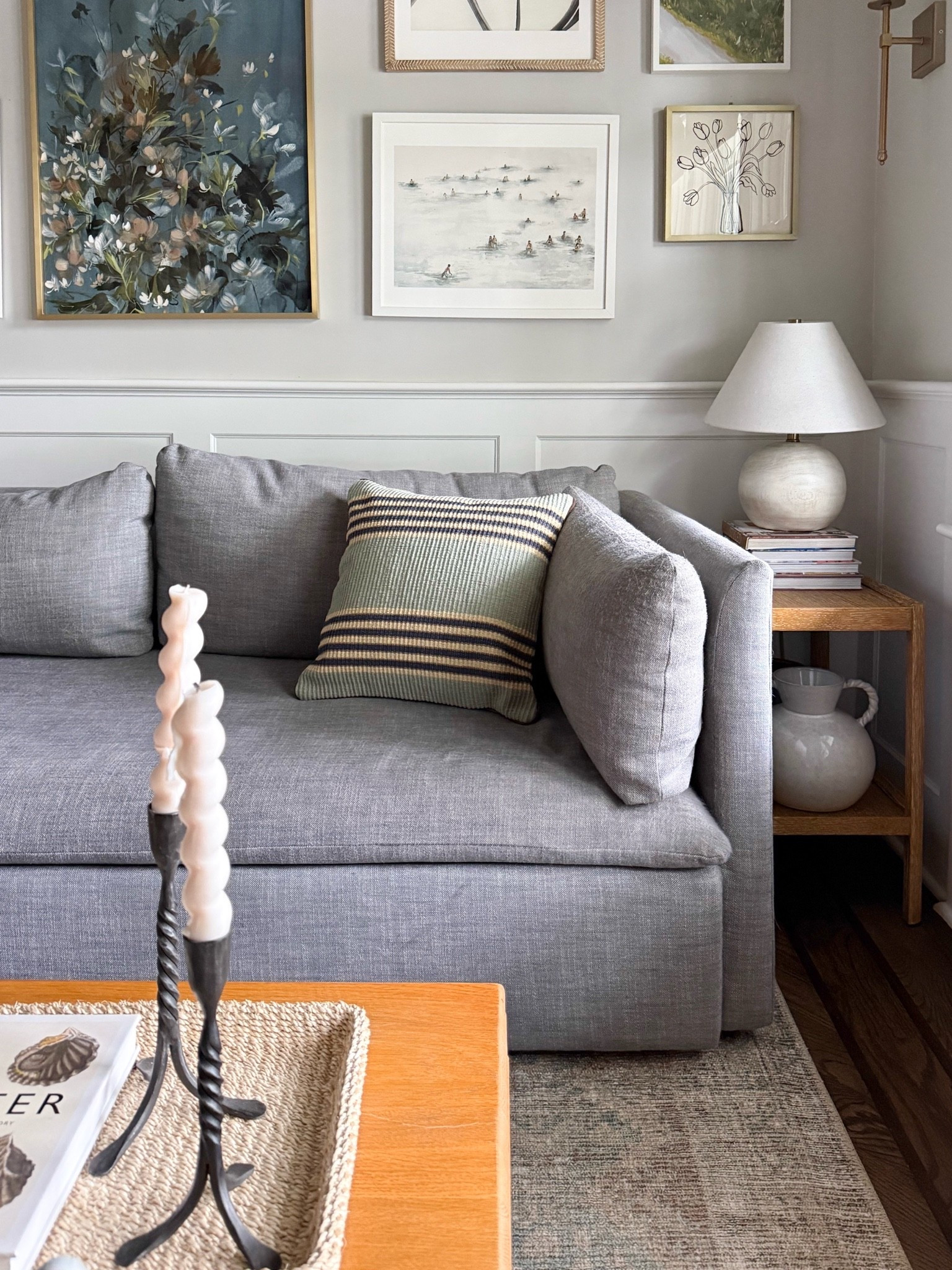 This living room is such a beautiful mix of classic and coastal style. The soft gray sofa, layered artwork, striped pillow, warm wood accents, and thoughtful styling details create a space that feels relaxed, collected, and timeless.

living room inspiration, coastal living room, gray sofa, gallery wall ideas, neutral home decor, striped throw pillow, coffee table styling, classic interior design, modern coastal home, layered home decor, cozy living room ideas, girlonthehudson

#LTKdayinmylife #LTKSeasonal #LTKHome