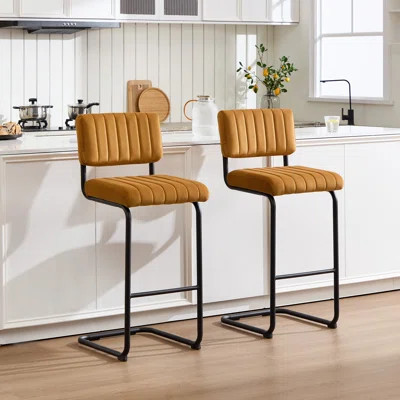 Mustard velvet counter stools with channel tufting and black sled bases, set of 2