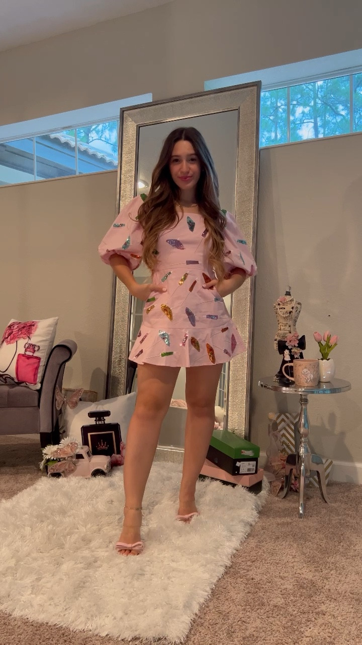 Cutest barbiecore look from queen of sparkles. Love the sequins and pockets! Wearing in an XS, perfect pink outfit to hop on the barbie trend. Barbie style is pink, sparkly, and feminine all shown in this girly dress. Love the addition of curls, a pink lipstick, and pink bow heels. Xoxo, Lauren 

#barbie #pink #dress #dresses #mini #ruffle #barbiecore #trending barbie movie, barbie outfits, pink dress, pink dresses, 80s style, pink heels, amazon fashion finds, amazon find 

#LTKsalealert #LTKshoecrush #LTKstyletip