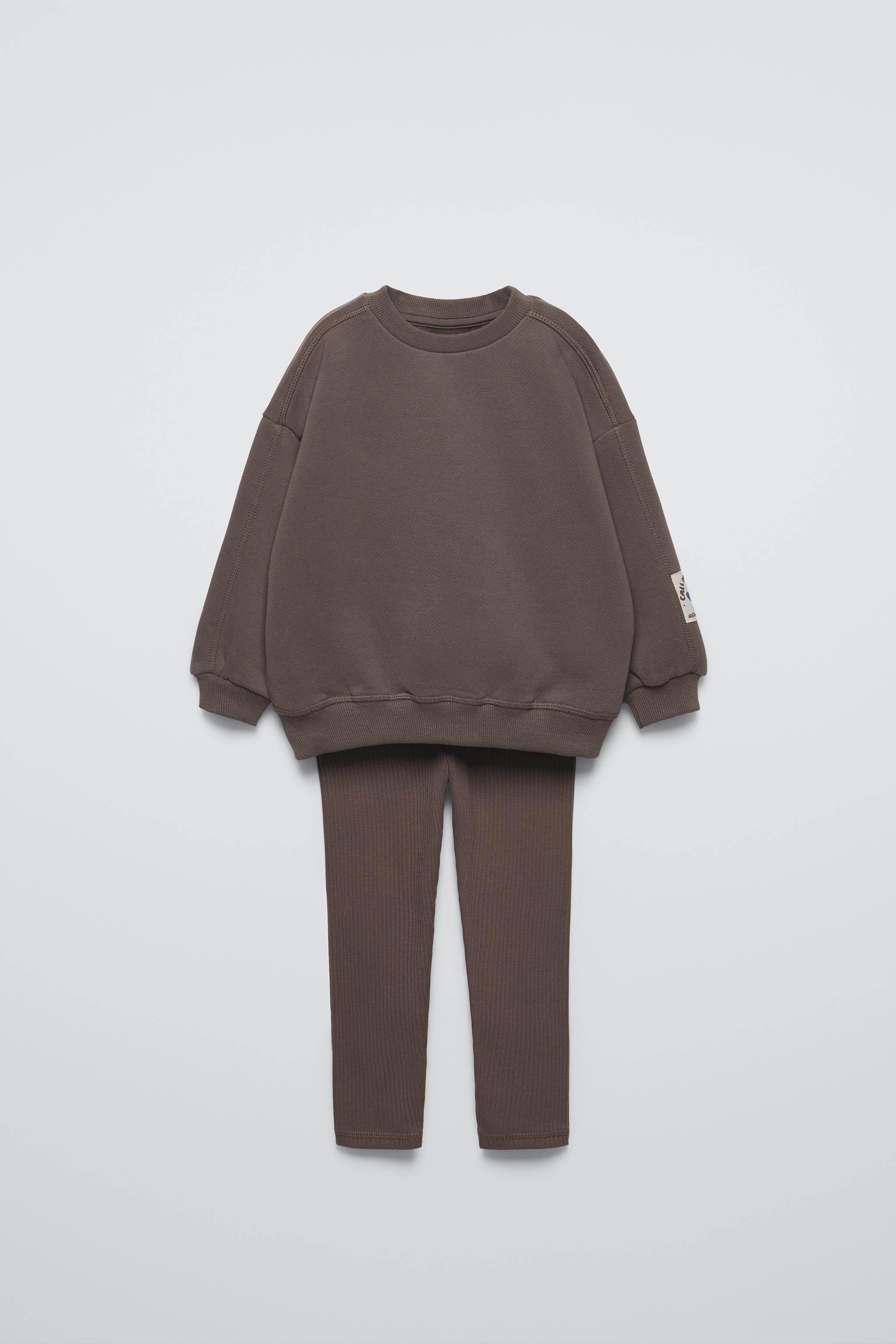 Two-piece matching set. Round neck sweatshirt with long sleeves. Rib trim. Label appliqué at sle... | Zara US