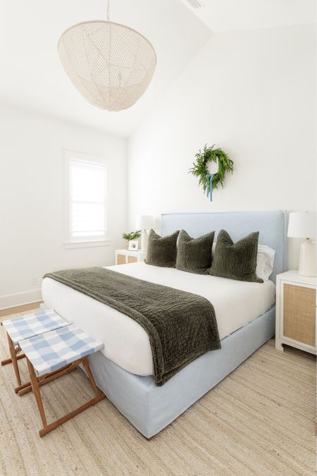 Our primary bedroom decorated for Christmas with our light blue linen bed (also linking a save version), rattan nightstands, dark green velvet bedding, white waffle blanket, large bead chandelier, buffalo check stools, natural braided rug, and a real touch wreath with light blue velvet ribbon! See our full Christmas home tour here: https://lifeonvirginiastreet.com/2023-coastal-christmas-home-tour/.

.
#ltkhome #ltkholiday #ltksalealert #ltkfindsunder50 #ltkfindsunder100 #ltkstyletip #ltkseasonal 

#LTKHoliday #LTKhome #LTKsalealert