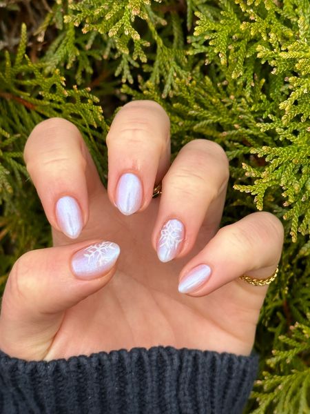 The most beautiful pearlescent, glazed donut mani at home using 1 coat of “The Queen Takes Her Tea With Milk” & 3 coats of “Pink Goldfish” both by Olive & June!💅🏻❄️ Snowflake nail art was created using the color “Cheers!” By O&J. 

#LTKunder50 #LTKGiftGuide #LTKSeasonal