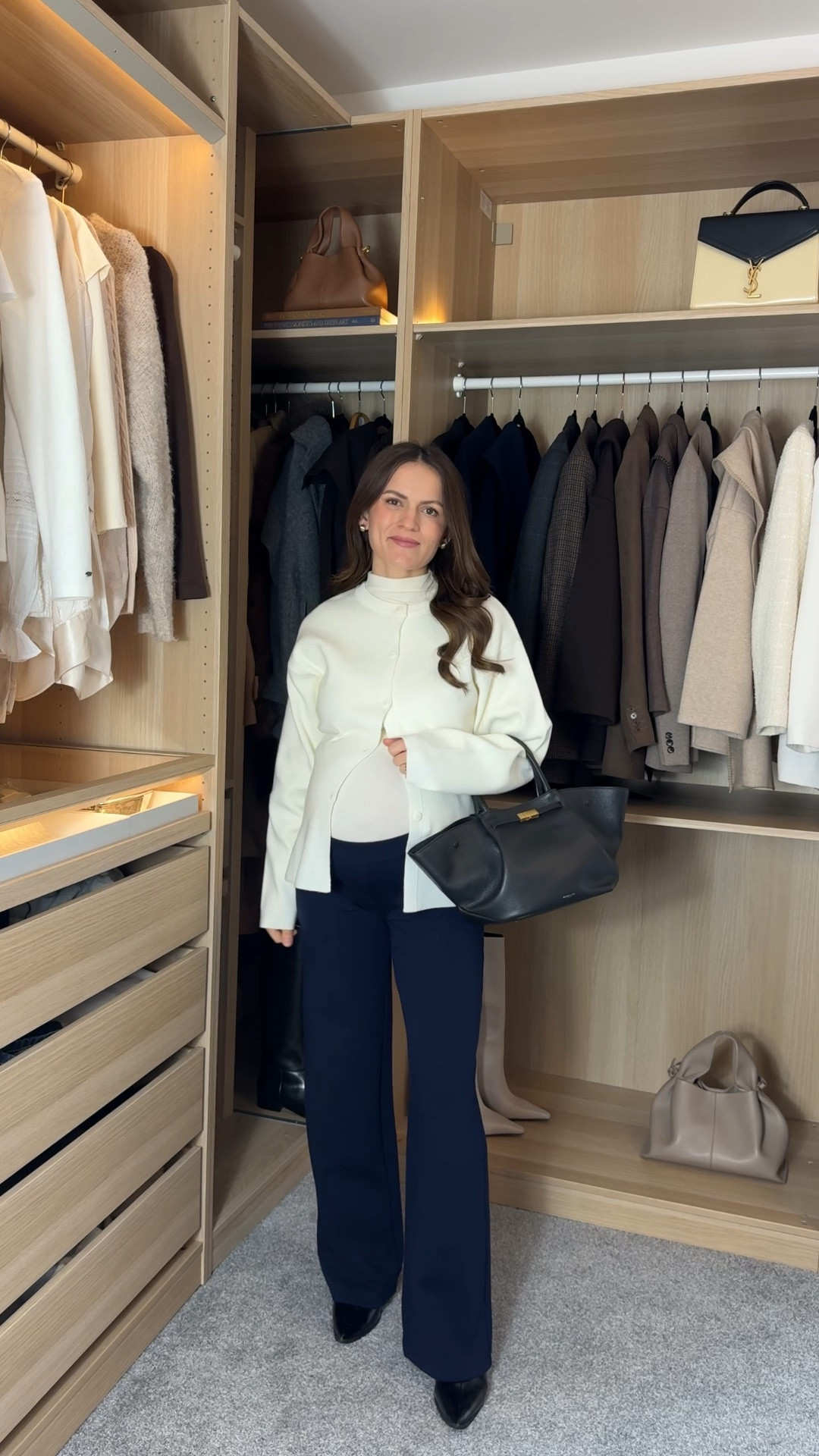 These trousers are super stretchy — I’m 37 weeks pregnant and they still fit perfectly in my pre-pregnancy size (Small). Comfortable, flattering, and something I’ll keep wearing postpartum.
The top is warm and cosy without feeling bulky, and the white cardigan adds exactly the elegance and structure the outfit needs. Wearing a small as well. 

The bag and shoes are the final touch that make the whole look feel polished and put together. ☺️

#LTKmodest #LTKworkwear #LTKmaternity