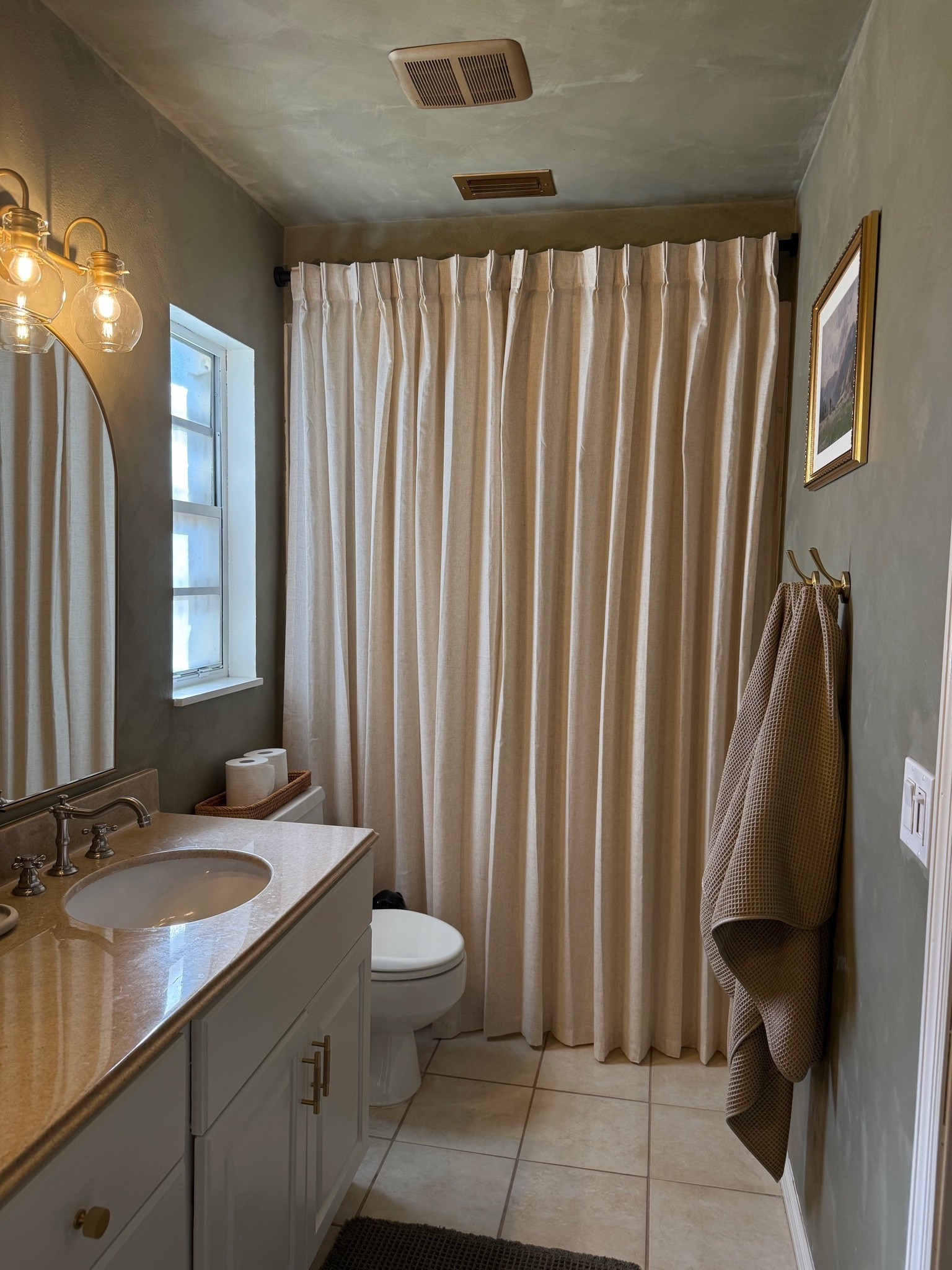 Small bathroom refresh 🤎 Proof you don’t need a full renovation to completely change the feel of a space. Paint, linen-look shower curtain, warm brass accents, + a few simple details made our older bathroom feel so much cozier and more collected.

#LTKHome