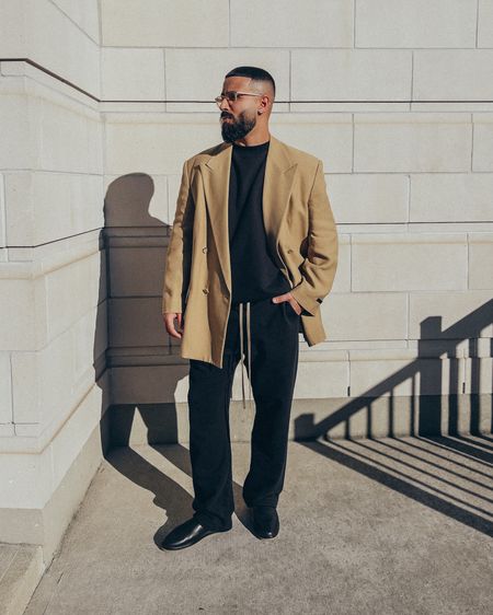 FEAR OF GOD California Blazer in ‘Camel’ (size 48), Overlapped 3/4 Sleeves Sweatshirt in ‘Black’ (size M), The Mule in black leather (size 41), and ETERNAL Relaxed Sweatpants in ‘Black’ (size M). FEAR OF GOD x BARTON PERREIRA glasses. A relaxed and elevated men’s look that’s perfect for a night out. Substitute the sweatpants for a pair of trousers for a business casual look for the office. The Mules are currently on sale for up to 60% off on sale. 

#LTKsalealert #LTKmens #LTKstyletip