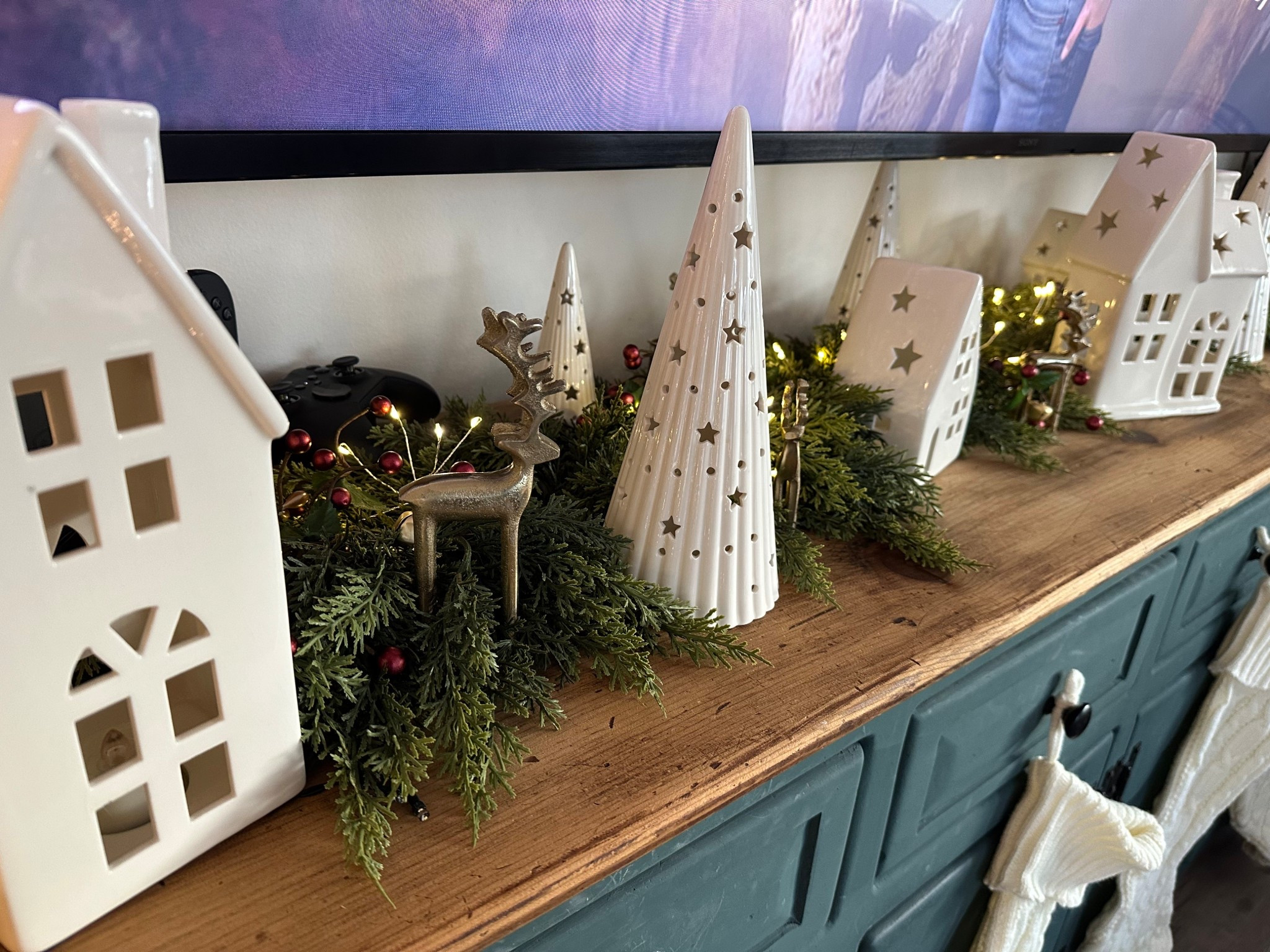 I just finished up my Christmas garland! I added little bells & berries for a pop of color and used my white ceramic house/tree set from Costco. Then I found little mini gold reindeer at home goods. I love how it all came together

#LTKHome #LTKSeasonal #LTKHoliday