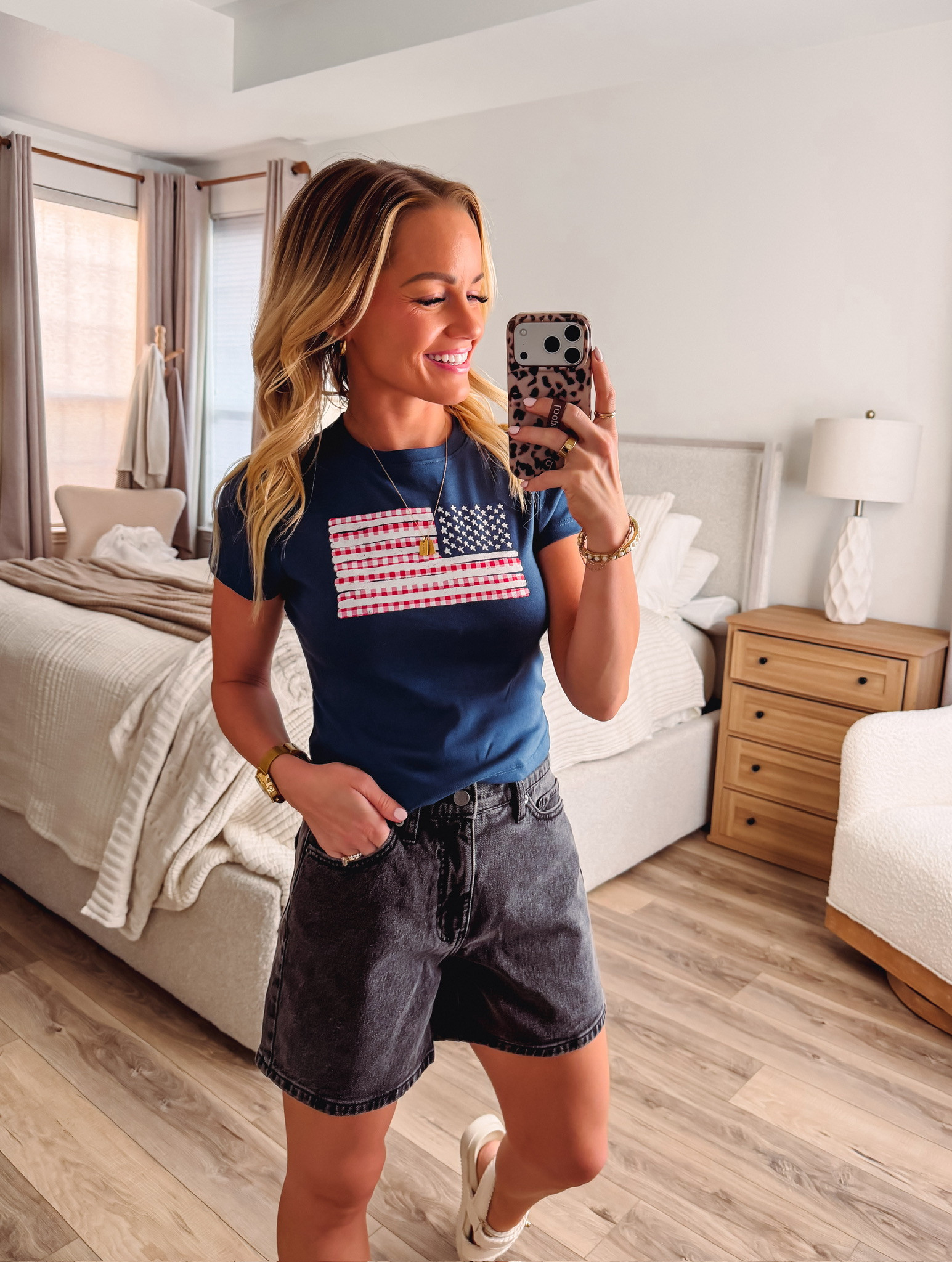 This American flag graphic tee with black denim shorts is perfect for summer! The baby tee fit is so cute and on-trend, and the patriotic graphic adds fun personality. Love how it pairs effortlessly with black denim for that classic casual look. Great for Fourth of July or any summer day! 

 #LTKootd #LTKmomlife #LTKSeasonal