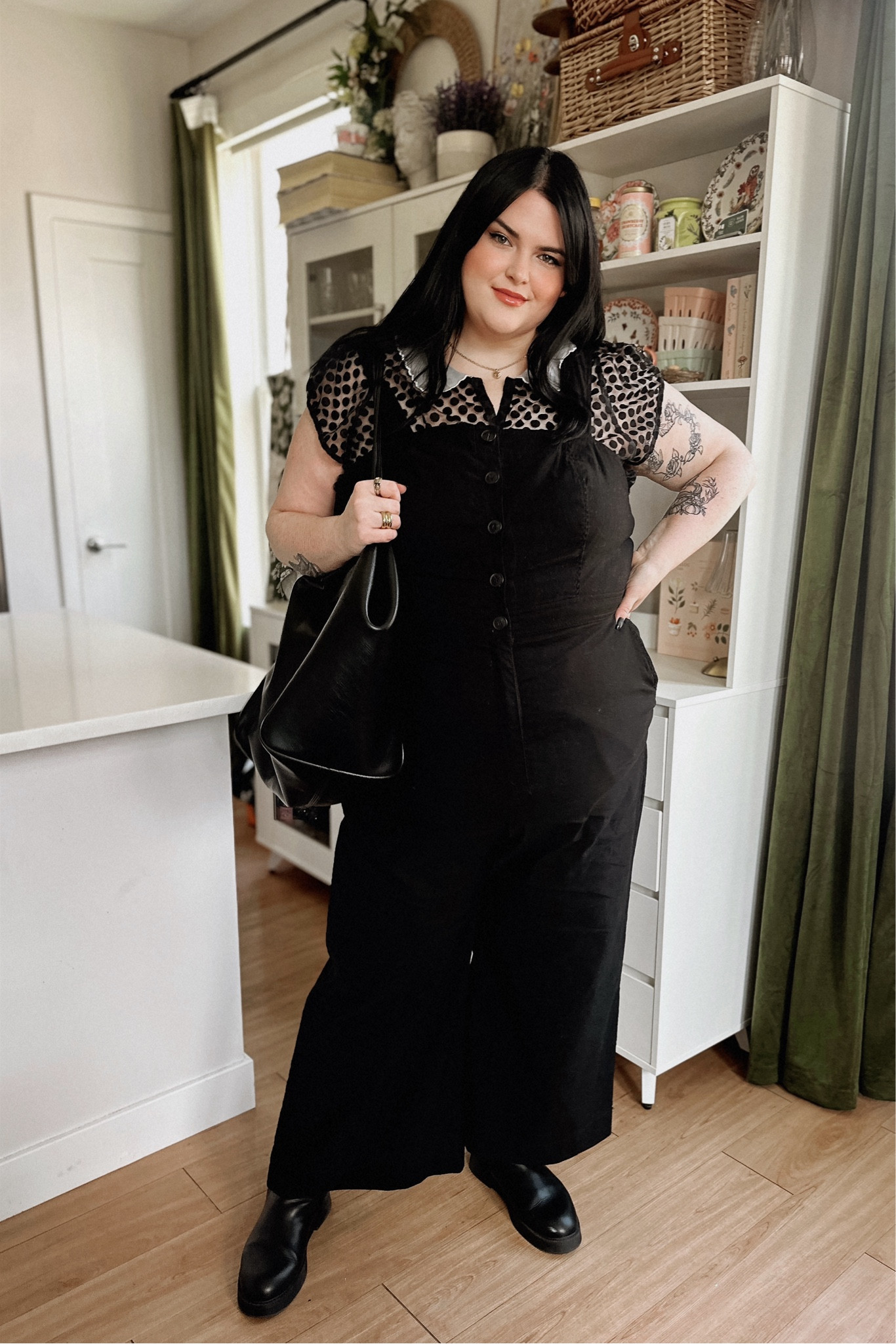 All black spring outfit! I love this jumpsuit from Anthropologie. It’s super stretchy and comfortable. I am wearing a size 22. If between sizes, size up. I layered a sheer top with it.  Wearing the side 2X. Has no stretch but is very blousey and loose. These boots are my favorite for walking around NYC and are very comfortable. Available in wide.  Follow me for more plus size dark aesthetic vibes  

#LTKplussize #LTKworkwear #LTKitbag