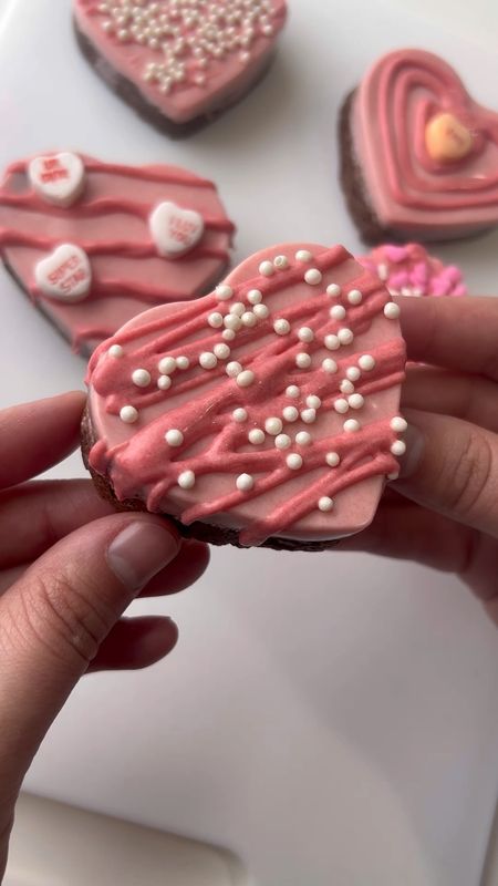 💖✨ Looking for the perfect Valentine's Day treat? Look no further! 🍫 These Chocolate Dipped Heart Brownies are a great Valentine's Day treat that will steal everyone's heart! 💕
Grab Yours Here: https://amzn.to/487GcAV

They're not only delicious but also super easy to make! Just mix up your favorite brownie mix and pour it 2/3 of the way up in a heart mold, then bake and let them cool. 🎂 Once cooled, melt some pink chocolate wafers and pour a little in the bottom of each mold before placing the brownies on top. 🍬

Let the chocolate set until it's hard, then remove the brownies from the mold and drizzle them with even more chocolate goodness! 🌟 Don't forget to sprinkle on your favorite sprinkles and heart-shaped decorations for that extra touch of love! 💝

Whether you're sharing them with your sweetheart, your friends, or just enjoying them solo, these Chocolate Dipped Heart Brownies are sure to make your Valentine's Day extra sweet! 😋 Who would you share these delightful treats with? Tag them below and spread the love! 💞 #ValentinesDayTreats #ValentinesDayChallenge #brownies #brownielovers #sweettreats #valentinesdaygifts 

#LTKVideo #LTKSeasonal #LTKMostLoved