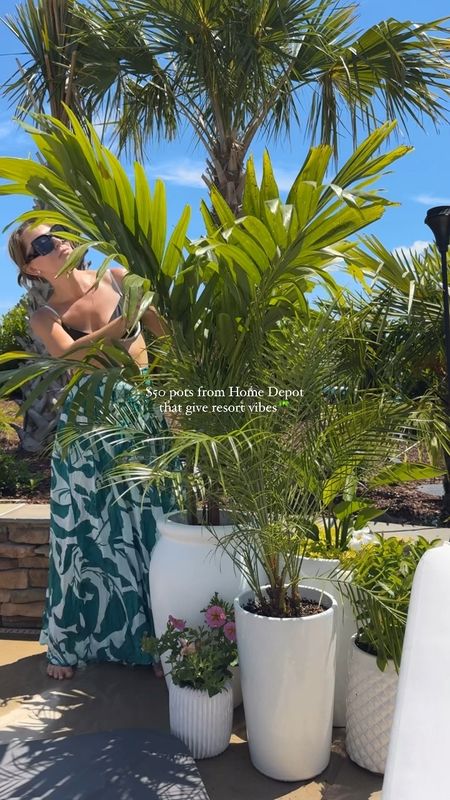 yall im obsessed! 😍 for $50 these huge white pots I found @homedepot scream tropical resort, pair them with the Adonidia Palm & it’s a vibe! 🌴 

save + share for outdoor inspo! ☀️
#outdoorliving #outdoorplants #homedepot #pooldesign #outdoorspace #flowerpot #plantingdesign #porchdecor 