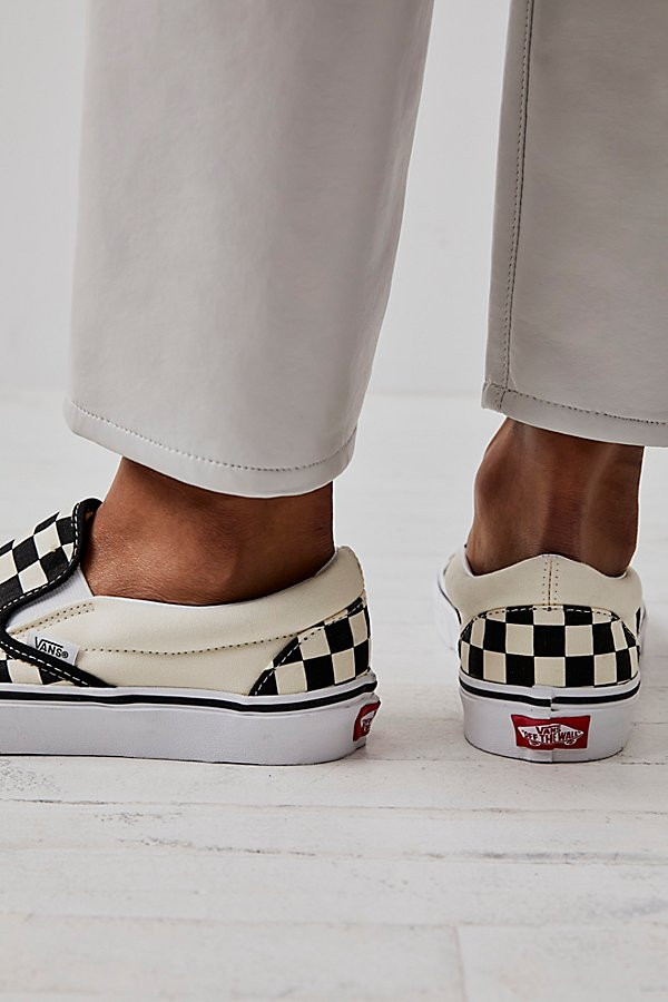Classic Checkered Slip-On by Vans at Free People, Black / White, US 4.5 | Free People (Global - UK&FR Excluded)