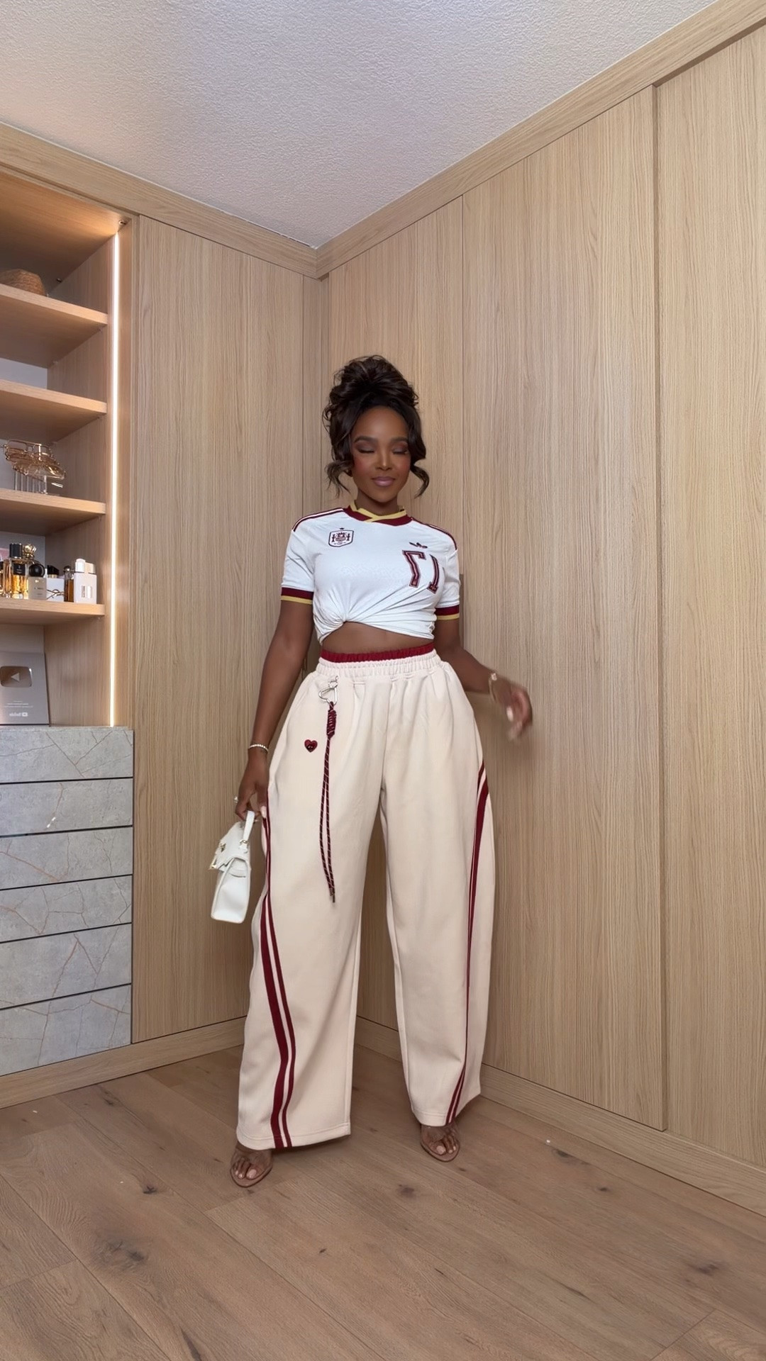Hi Babes! 🤍❤️

This sporty-chic set is giving designer vibes without the designer price tag. I love how the oversized track pants balance the cropped jersey top—it's the perfect mix of comfy and trendy!

⚽ Sporty jersey-inspired crop top
🤍 Wide-leg track pants with side stripe detail
✨ Styled with a mini white bag and neutral sandals

Everything is linked below!

xx, Kira | IG: KirasFashionFinds

Measurements:
Kira: 5'4" | Size Small | 140 lbs