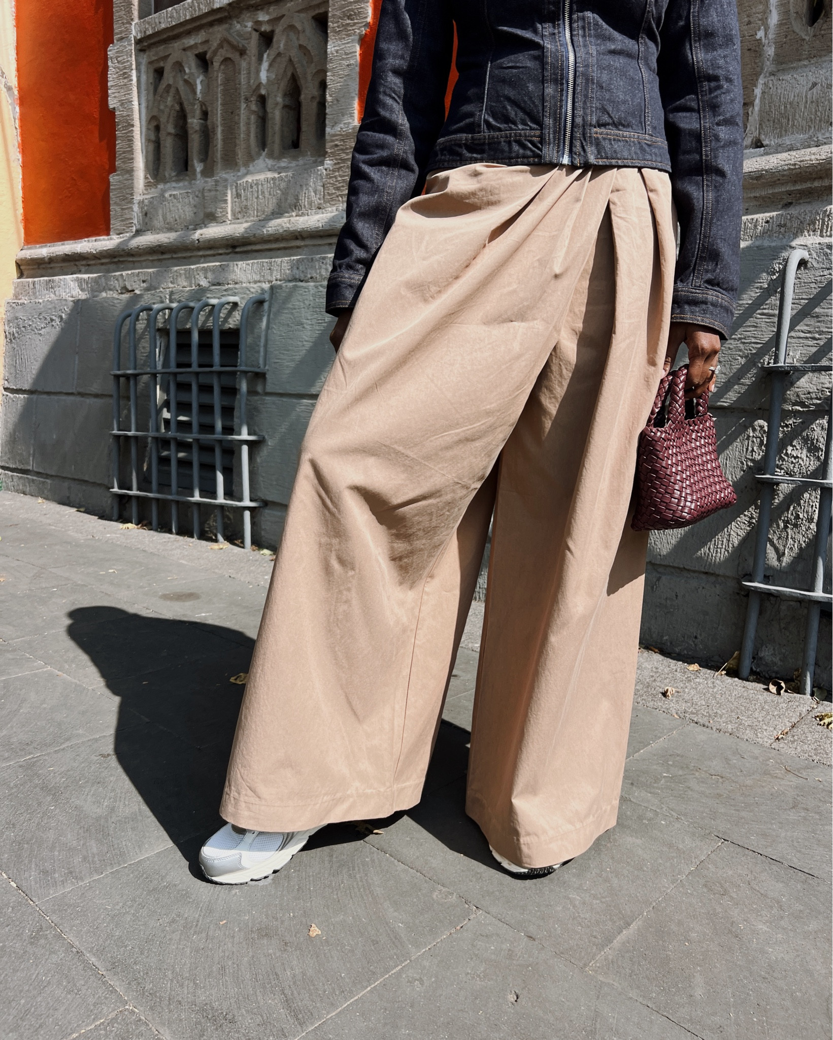 Unique wide leg pants, tailored zip up denim jacket with silver white new balance sneakers and burgundy mini woven purse. My outfit for exploring Mexico City  

#LTKgrwm
