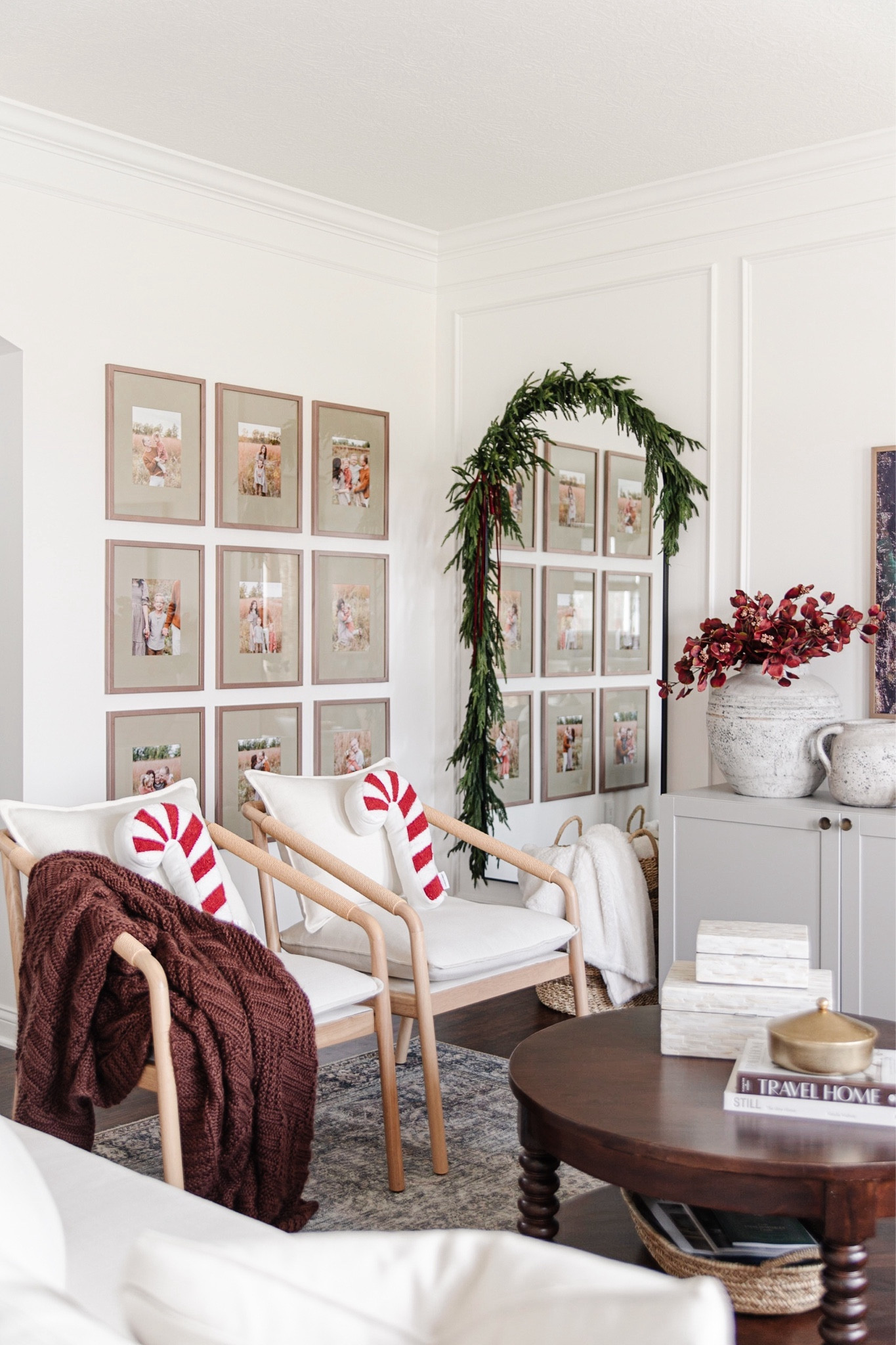 Cozy christmas living room decor, real touch garland over arched mirror, burgundy velvet ribbon, burgundy throw blanket, wood frame accent chairs

#LTKSeasonal #LTKhome #LTKHoliday