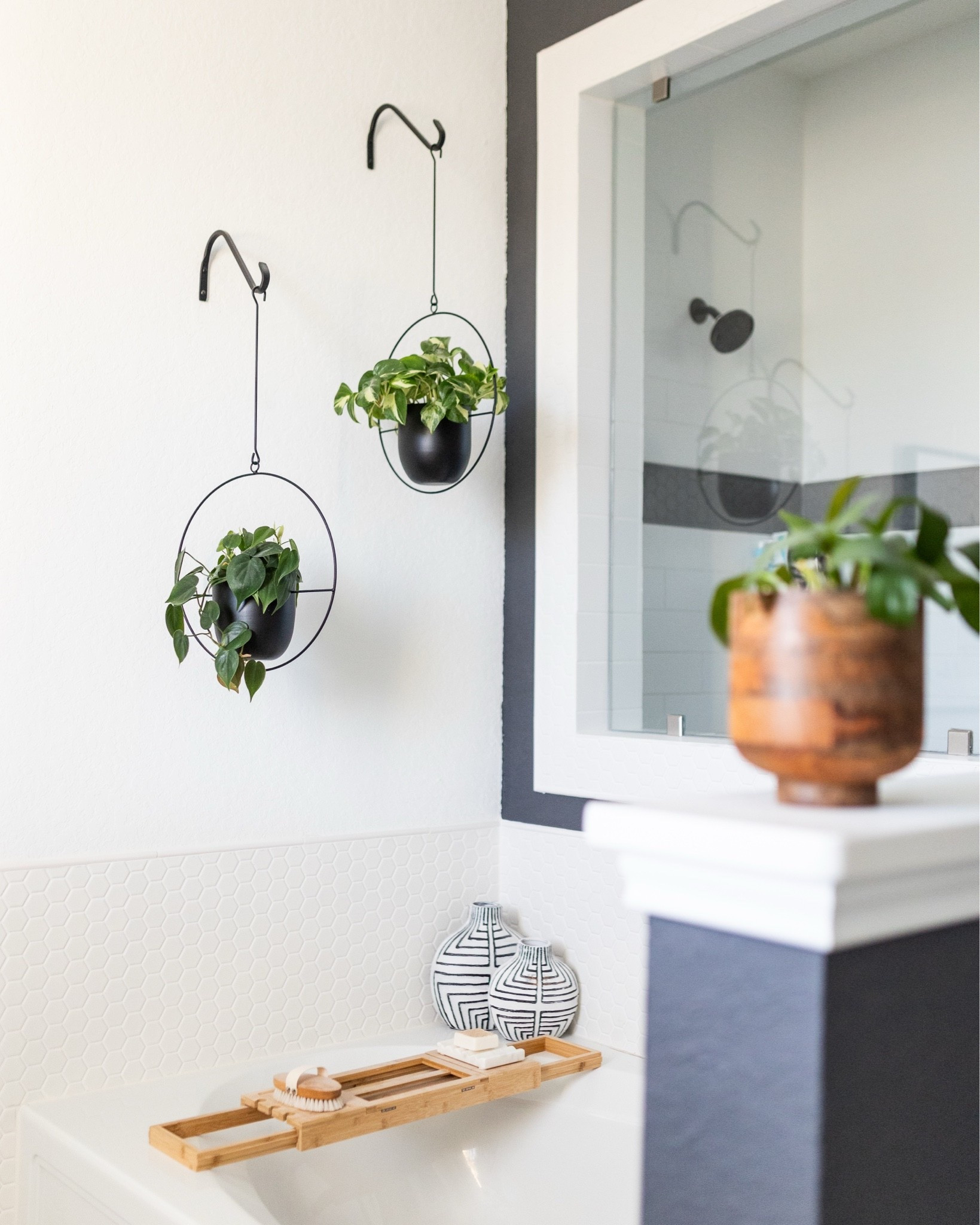 One simple way to elevate your bathroom: add a bathtub caddy and some hanging plants 🪴

#LTKHome