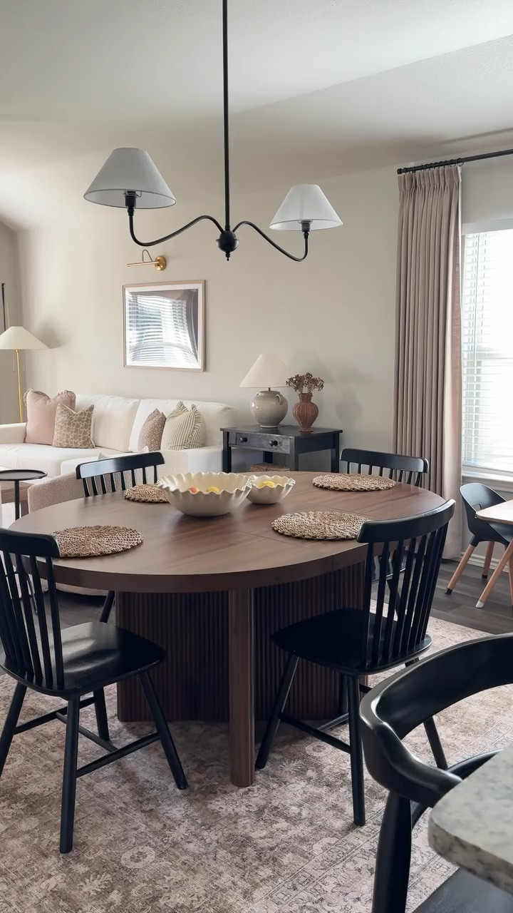 my dream dining area! we don’t have a formal dining room, just this space between our kitchen and living room, but i still wanted it to feel like its own space so separating it with a rug and pendant light helped so much! proof you don’t need a dedicated dining room to create a space that feels intentional and inviting. 🤎 comment “shop” and i’ll send you all the links! 
#diningroom #diningtable #diningroomdecor #diningroommakeover #homeinspo 

dining room dining area dining nook builder grade home builder grade home update creating a cozy home home decor on a budget home inspiration interior design home decor inspiration curated home intentional home decor